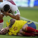 Peru's Aldo Corzo taunts Colombia's James Rodriguez after falling on the pitch during a qualifying soccer match for the FIFA World Cup Qatar 2022 at the Roberto Melendez stadium in Barranquilla, Colombia, Friday, Jan. 28, 2022. (AP Photo/Fernando Vergara)