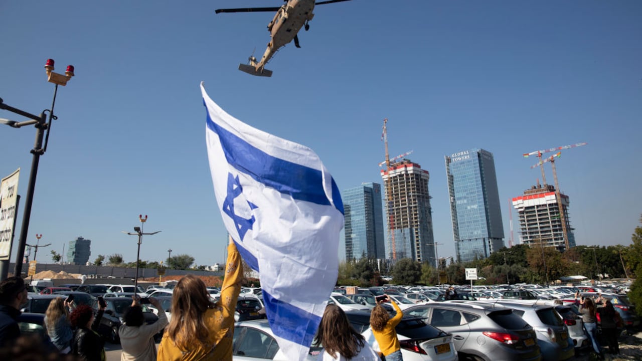 PETAH TIKVA, ISRAEL - JANUARY 30: A woman holds an Israeli flag as an army helicopter carrying newly released hostage Agam Berger is landing at Beilinson hospital on January 30, 2025 in Petah Tikva, Israel. Today was the third day on which hostages were released from Gaza under phase one of the Israel-Hamas ceasefire agreement. (Photo by Amir Levy/Getty Images)