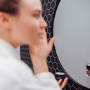 Young woman in bathrobe, concept of skincare routine.