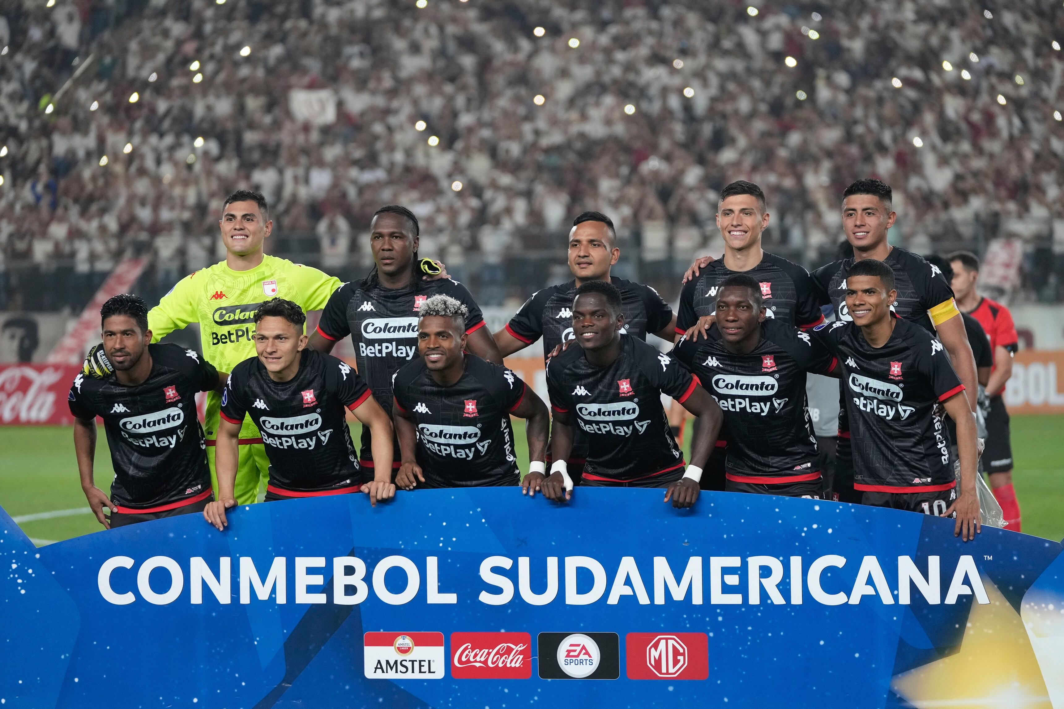 The starting players of Colombia's Independiente Santa Fe pose for a team photo prior to a Copa Sudamericana group G soccer match against Peru's Universitario at Monumental stadium in Lima, Peru, Thursday, May 4, 2023. (AP Photo/Martin Mejia)