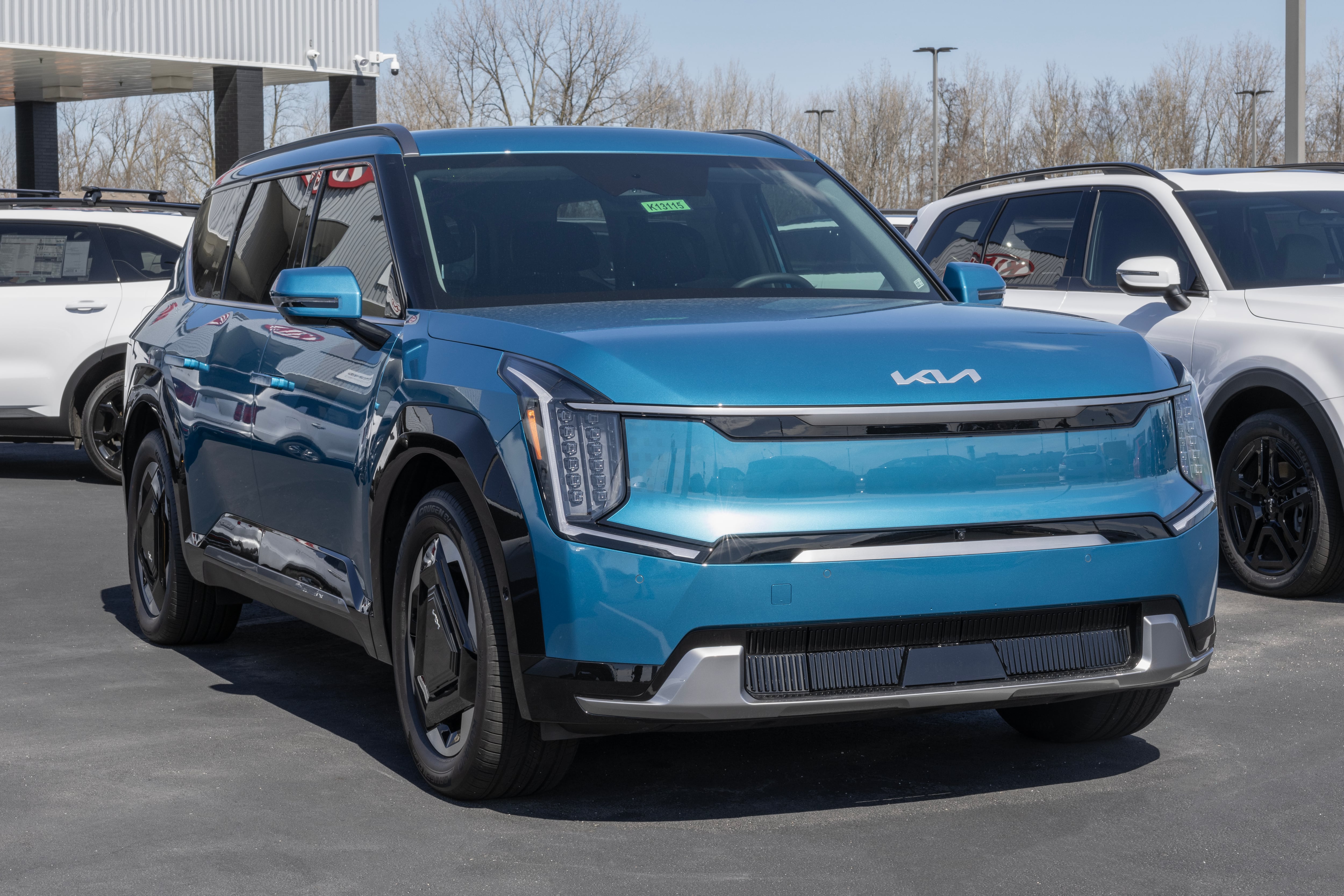 Milton Keynes,Bucks,UK - Dec 9th 2023:  2023 yellow Kia Sportage GT line SUV car driving on a wet road, in the rain with headlights on