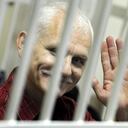 (FILES) In this file photo taken on November 02, 2011 A photo taken through the bars of the defendant�s cage shows the head of Vyasna (Spring) rights group, Ales Beliatsky, in a court in Minsk. - The Norwegian Nobel Committee awarded the 2022 Nobel Peace Prize to human rights advocate Ales Bialiatski from Belarus, the Russian human rights organisation Memorial and the Ukrainian human rights organisation Center for Civil Liberties. (Photo by VIKTOR DRACHEV / AFP)