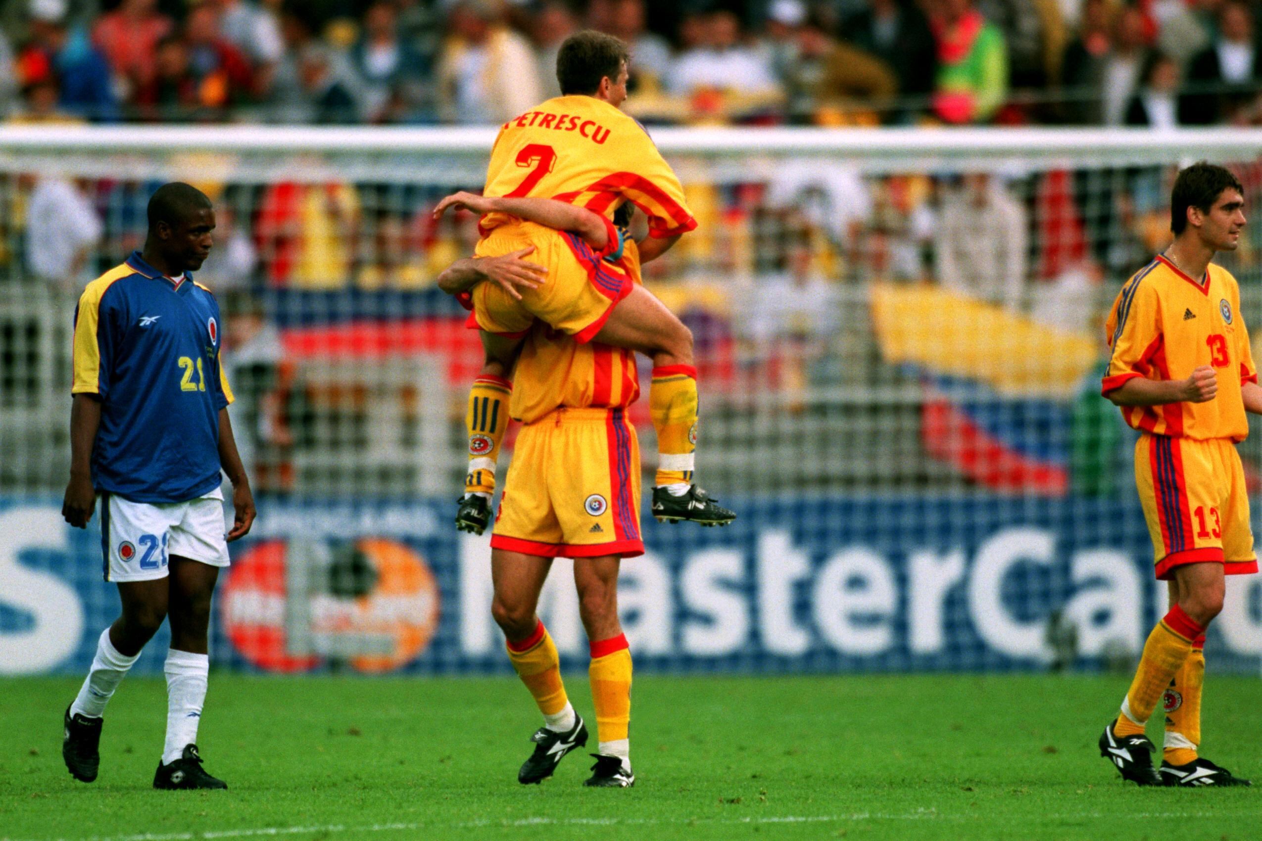 Romania's Dan Patrescu (right top) celebrates with Gheorghe Popescu (right back) as Colombia's Leider Preciado (left) looks on dejected  (Photo by Matthew Ashton/EMPICS via Getty Images)