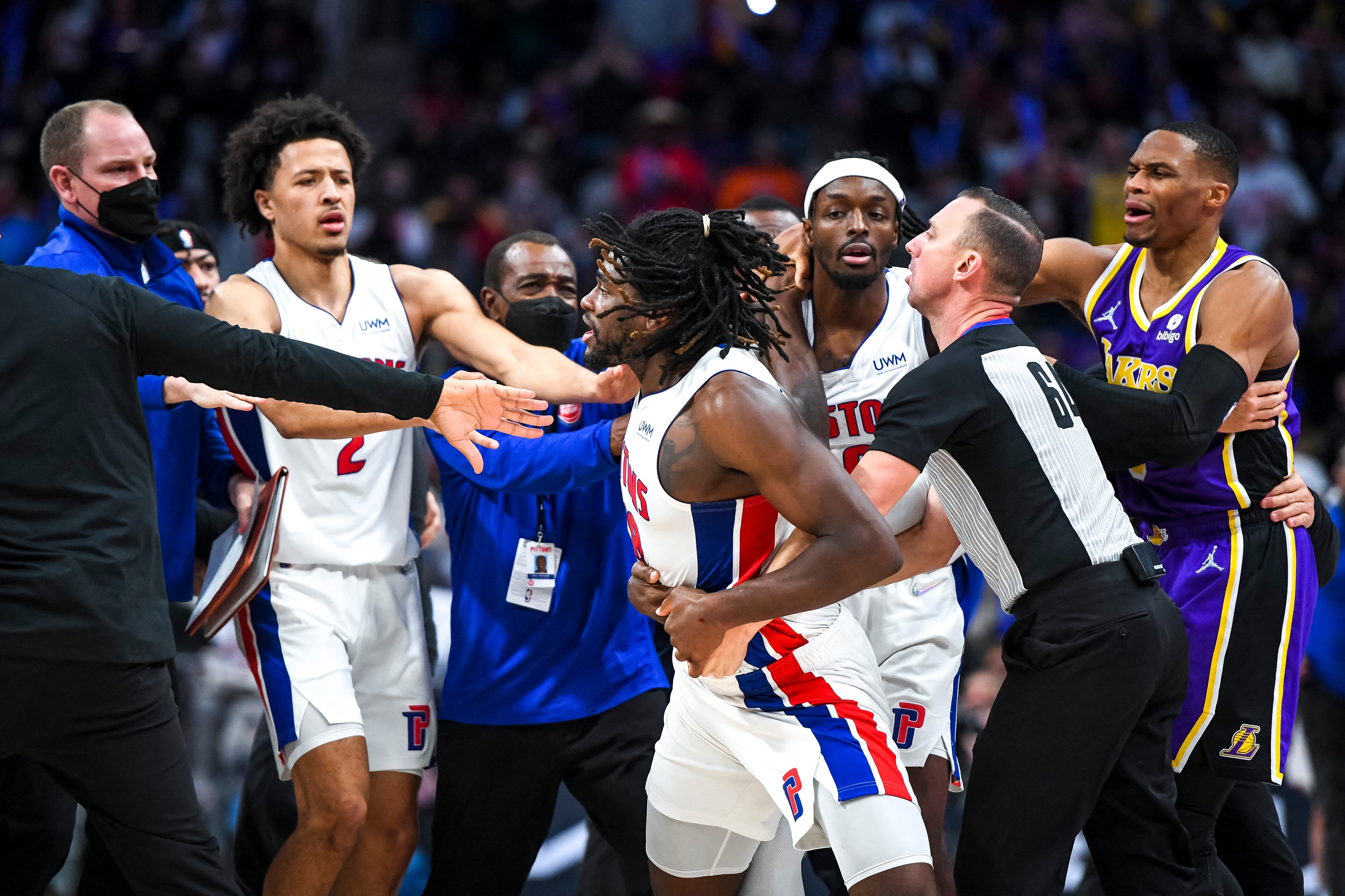 DETROIT, MICHIGAN - NOVEMBER 21: Isaiah Stewart #28 of the Detroit Pistons is restrained as he goes after LeBron James #6 of the Los Angeles Lakers during the third quarter of the game at Little Caesars Arena on November 21, 2021 in Detroit, Michigan. NOTE TO USER: User expressly acknowledges and agrees that, by downloading and or using this photograph, User is consenting to the terms and conditions of the Getty Images License Agreement.   Nic Antaya/Getty Images/AFP (Photo by Nic Antaya / GETTY IMAGES NORTH AMERICA / Getty Images via AFP)