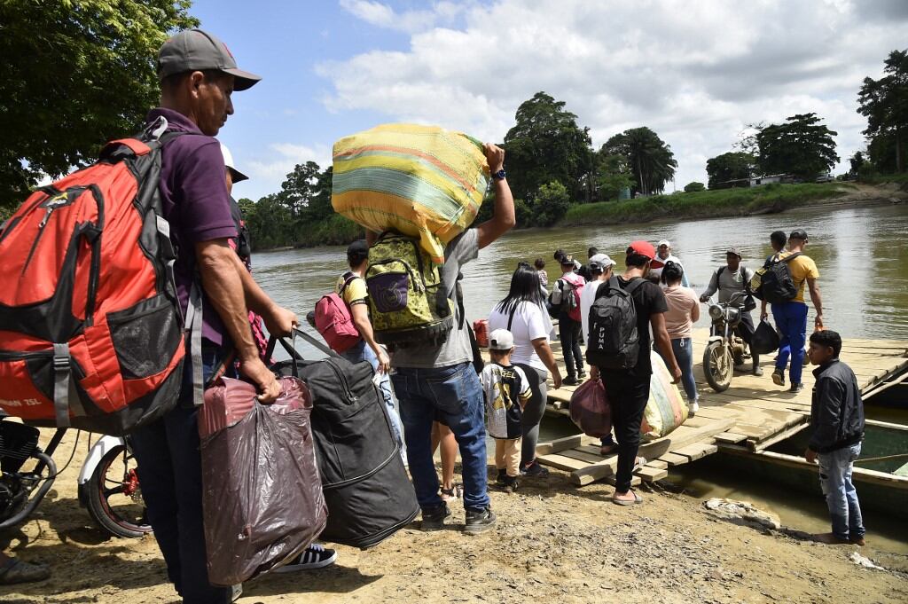 Personas desplazadas por recientes enfrentamientos entre grupos armados abordan canoas para cruzar el río Tarra, que divide a Colombia y Venezuela, en Tibú, departamento de Norte de Santander, Colombia, el 19 de enero de 2025. Un nuevo brote de violencia guerrillera en medio de un proceso de paz tambaleante en Colombia, plagada de conflictos, ha dejado más de 80 personas muertas en poco más de tres días, informaron funcionarios el domingo. El grupo armado Ejército de Liberación Nacional (ELN) lanzó el jueves pasado un asalto en la nororiental región del Catatumbo contra una formación rival compuesta por exmiembros de la extinta guerrilla de las FARC que siguió luchando luego de que ésta se desarmó en 2017. (Foto de Schneyder Mendoza /AFP)