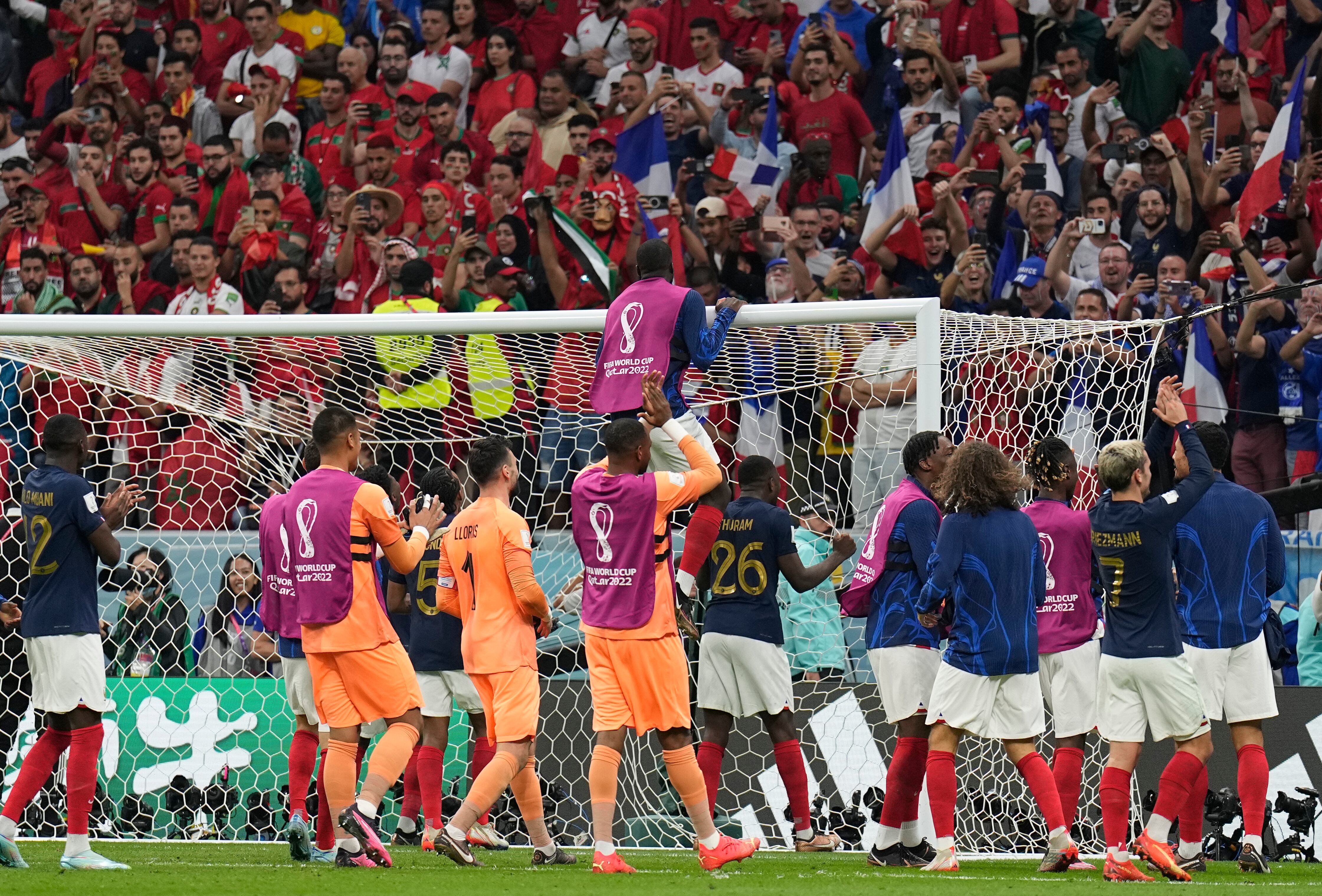 France's players celebrate after winning the World Cup semifinal soccer match between France and Morocco at the Al Bayt Stadium in Al Khor, Qatar, Wednesday, Dec. 14, 2022. (AP Photo/Martin Meissner)