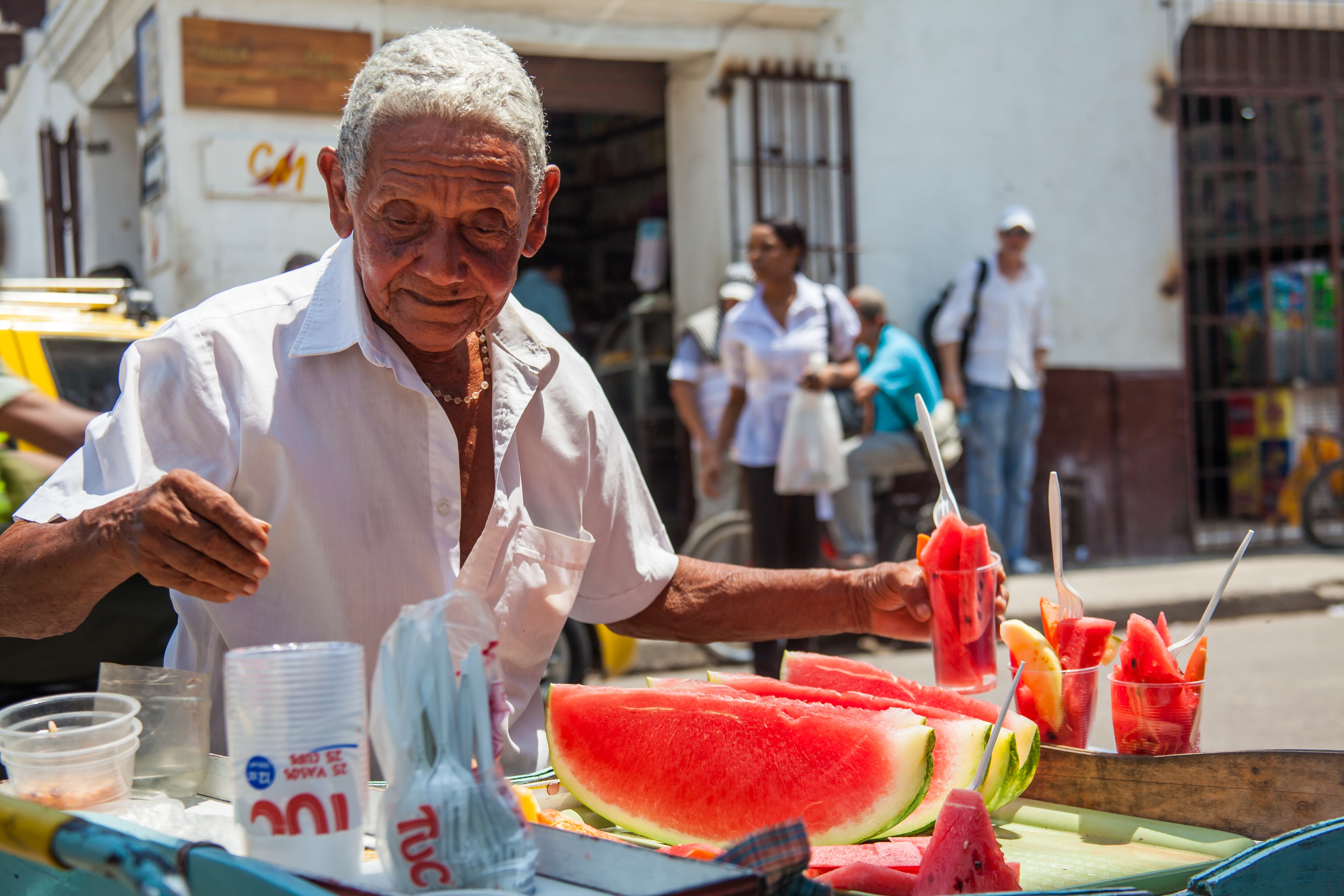 Cartagena De Indias, Colombia - August, 2011: Senior adult selling watermelon in the colonial Getsemani neighborhood in Cartagena de Indias