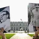 A youth holds a picture of late Chilean President (1970�1973) Salvador Allende (L) and Chilean dictator Augusto Pinochet outside La Moneda Presidential Palace in Santiago, on August 1, 2023. Chile marks the 50th anniversary of general Augusto Pinochet's 1973 military coup on September 11, 2023. (Photo by Martin BERNETTI / AFP)