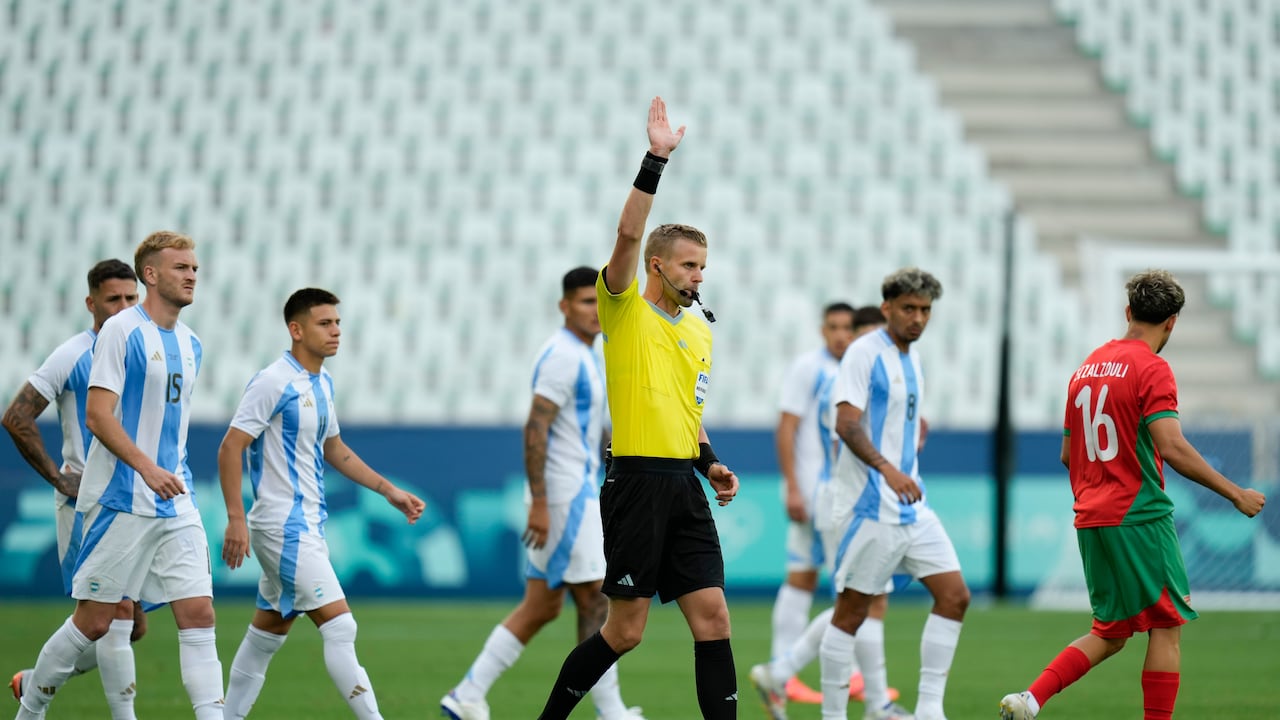 Referee Glenn Nyberg disallows a goal scored by Argentina's Cristian Medina during the Men's Group B soccer match between Argentina and Morocco at Geoffroy-Guichard stadium during the 2024 Summer Olympics, Wednesday, July 24, 2024, in Saint-Etienne, France. (AP Photo/Silvia Izquierdo)