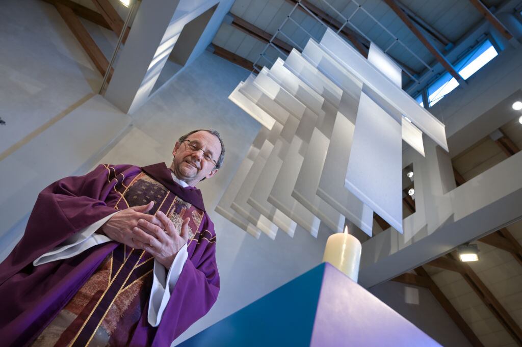 PRODUCTION - 24 February 2023, Saxony-Anhalt, Halle (Saale): Catholic priest Magnus Koschig stands in his purple priestly robe under the cross in Halle's Church of the Holy Cross. The 62-year-old assumes that in just ten years there will be only 20 priests in the diocese of Magdburg instead of the current 55 due to aging. (to dpa "Fewer priests, more laity: Catholic diocese in transition") Photo: Heiko Rebsch/dpa (Photo by Heiko Rebsch/picture alliance via Getty Images)