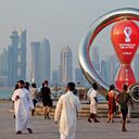 A picture taken on October 20, 2022, shows people walking past the Qatar 2022 FIFA World Cup countdown clock as it nears marking thirty days, in the Qatari capital Doha.
Karim JAAFAR / AFP