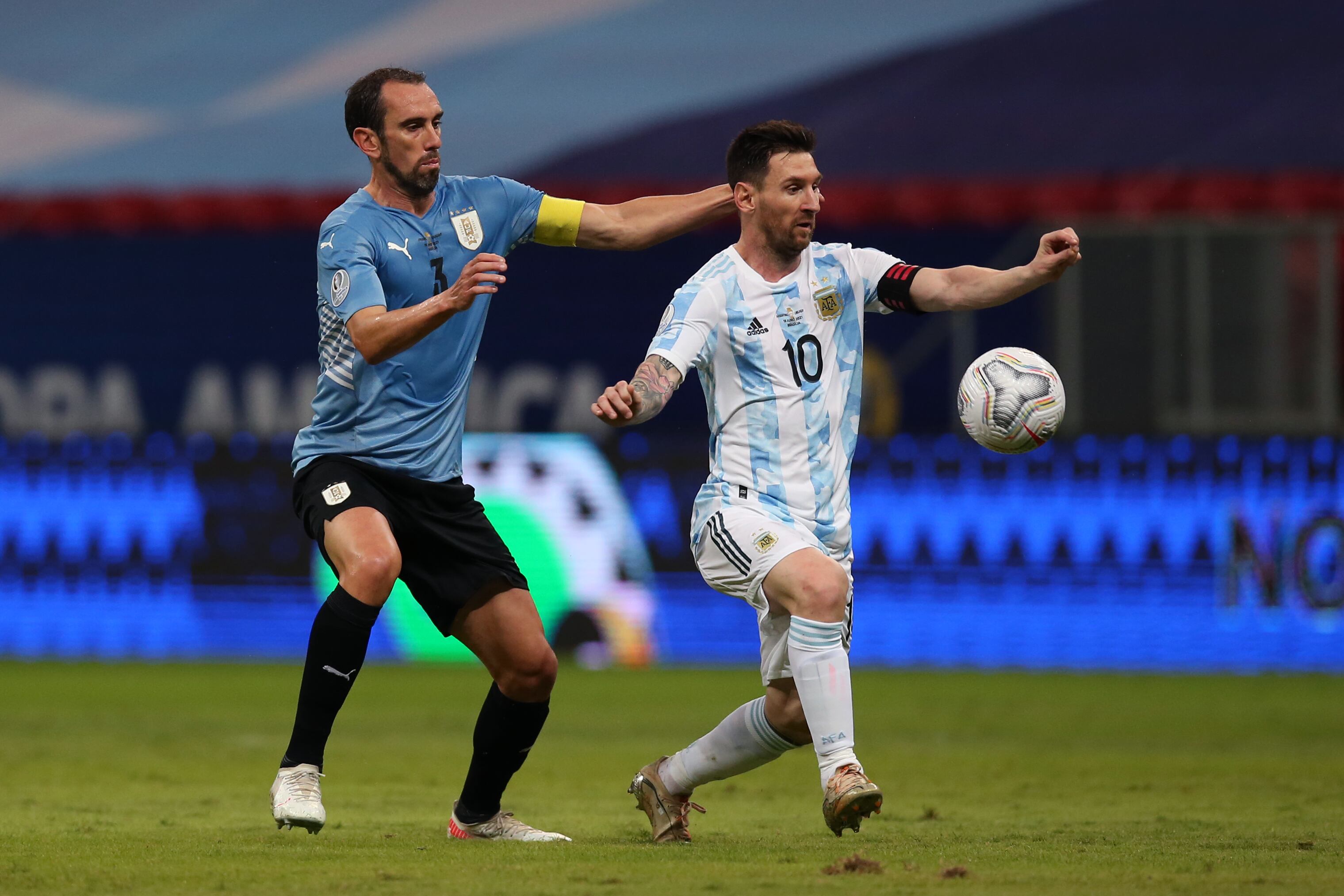 BRASILIA, BRAZIL - JUNE 18: Lionel Messi of Argentina and Diego Godin of Uruguay compete for the ball during a group A match between Argentina and Chile as part of Conmebol Copa America Brazil 2021 at Mane Garrincha Stadium on June 18, 2021 in Brasilia, Brazil. (Photo by Alexandre Schneider/Getty Images)