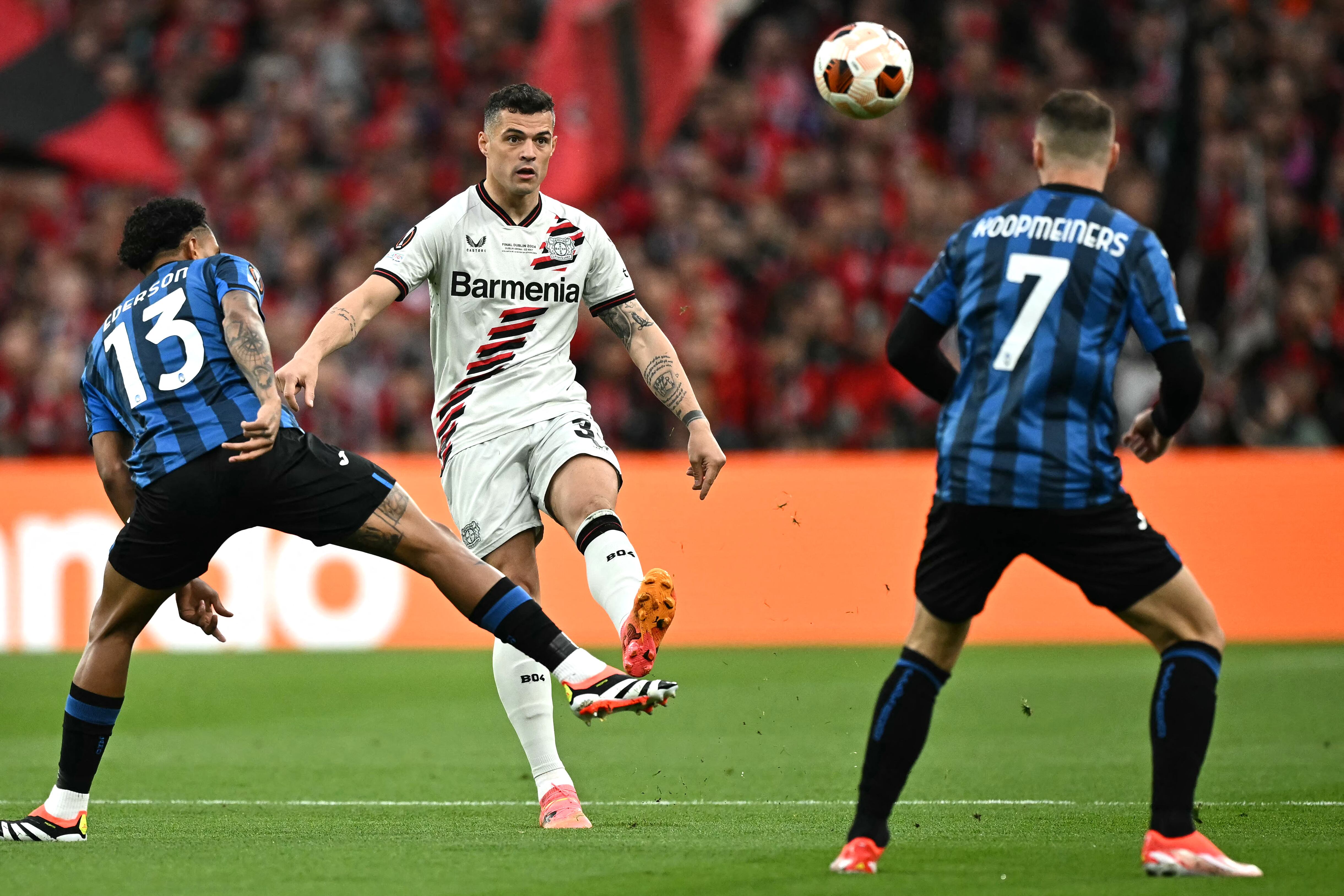 Bayer Leverkusen's Swiss midfielder #34 Granit Xhaka (C) kicks the ball during the UEFA Europa League final football match between Atalanta and Bayer Leverkusen at the Dublin Arena stadium, in Dublin, on May 22, 2024. (Photo by Ben Stansall / AFP)