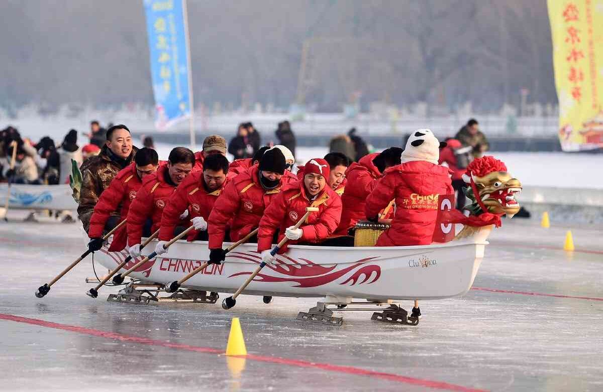 En embarcaciones adornadas con un dragón, cuya cabeza se ubica en la proa y cola en la popa, los equipos se miden durante una competencia de Dragon Boat sobre hielo en Shenyang, en la provincia de Liaoning, noreste de China, el 3 de enero de 2020. (Foto de STR / AFP) / China OUT / 