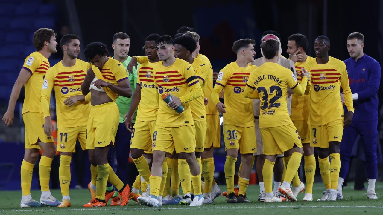 Barcelona players celebrate after the Spanish La Liga soccer match between Espanyol and Barcelona at the RCDE stadium in Barcelona, Sunday, May 14, 2023. (AP/Joan Monfort)