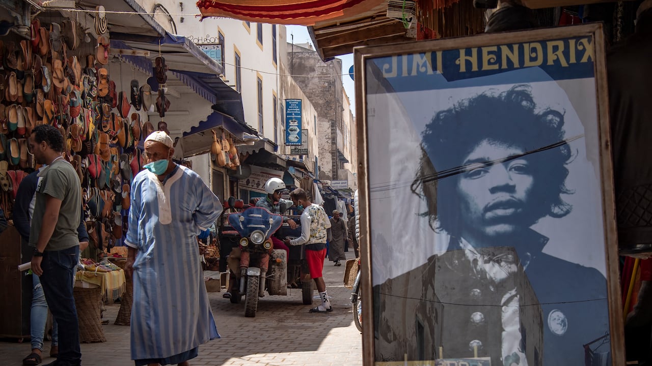 A picture taken in the Moroccan coastal city of Essaouira shows portraits of late US guitarist Jimi Hendrix on September 10, 2020. - Some claim to have seen him, others to have spoken with him -- 50 years after guitar legend Jimi Hendrix's untimely death, a village on Morocco's Atlantic coast pulsates with his memory. In the Summer of 1969, Hendrix, the pioneering US guitar wizard whose whose hits included "Purple Haze" and "Hey Joe", made a brief stop in Essaouira, a former fort town and latter day tourist magnet located five kilometres (three miles) from his childhood village. (Photo by FADEL SENNA / AFP)