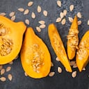 Orange pumpkin cut into pieces with seeds