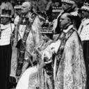 FILE - Britain's Queen Elizabeth II is crowned the Monarch of Britain holding the Royal Scepter, sat on throne, wearing St. Edward's crown, at Westminster Abbey, in London, June 2, 1953. Britain’s royal family turns the page on a new chapter with the coronation of King Charles III. Charles ascended the throne when his mother, Queen Elizabeth II, died last year. But the coronation Saturday is a religious ceremony that provides a more formal confirmation of his role as head of state and titular head of the Church of England. (AP Photo, File)