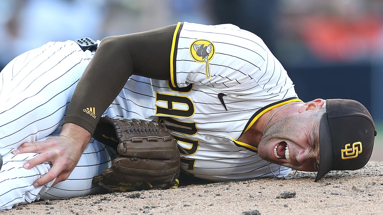 SAN DIEGO, CALIFORNIA - SEPTEMBER 01: Jason Adam #40 of the San Diego Padres grimaces in pain after huring himself on a pitch during the seventh inning of a game against the Baltimore Orioles at Petco Park on September 01, 2025 in San Diego, California. (Photo by Sean M. Haffey/Getty Images)