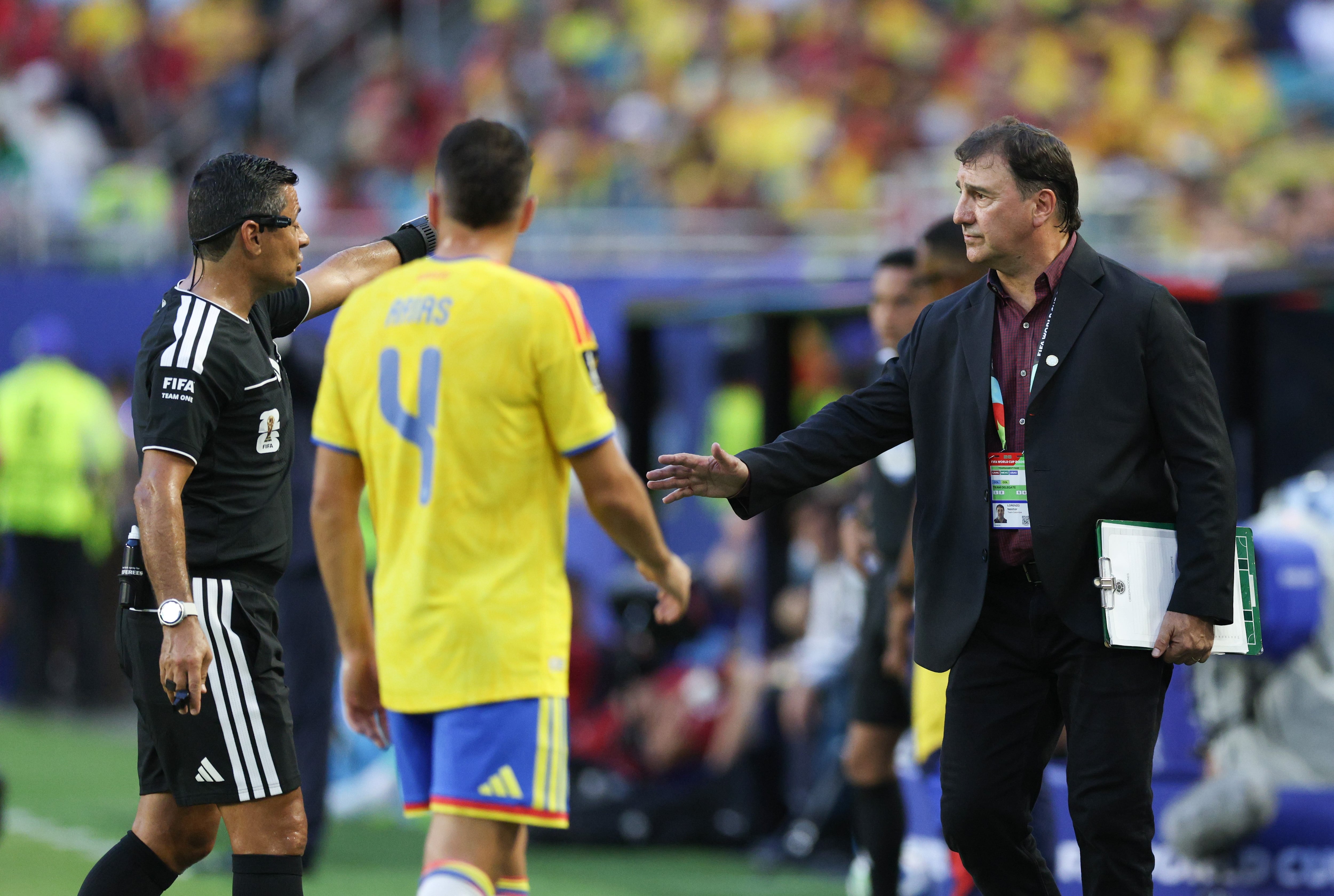 Nestor Lorenzo R, head coach of Colombia, communicates with Referee Alireza Faghani L during the group K match between Colombia and Portugal at the 2026 FIFA World Cup at Miami Stadium, Miami, the United States, June 27, 2026. (Photo by Xu Zijian/Xinhua via Getty Images)