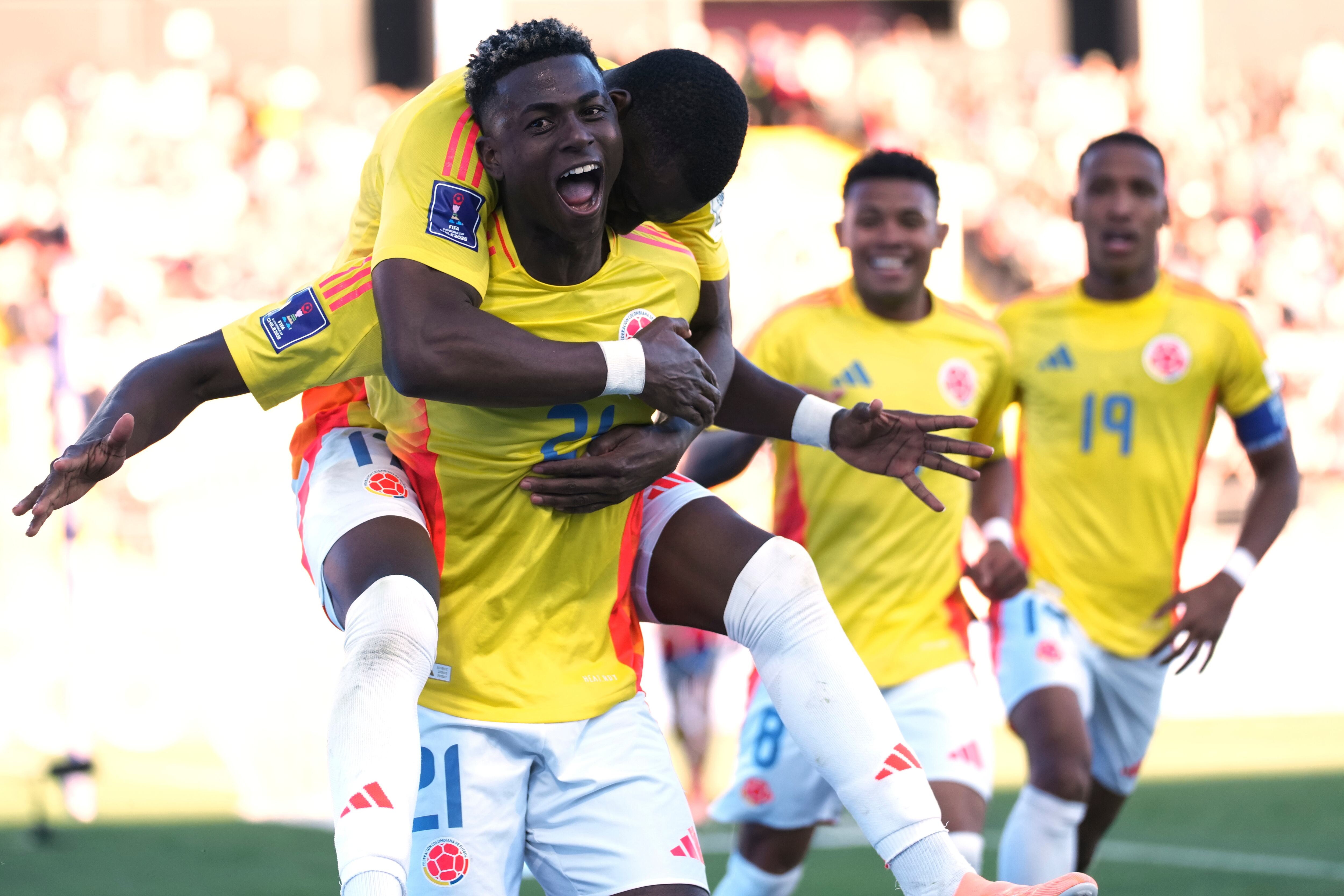 Colombia's Neyser Villareal, left, celebrates scoring his side's third goal against Spain with teammates during a FIFA U-20 World Cup quater-final soccer match at Fiscal Stadium in Talca, Chile, Saturday, Oct. 11, 2025. (AP Photo/Andre Penner)