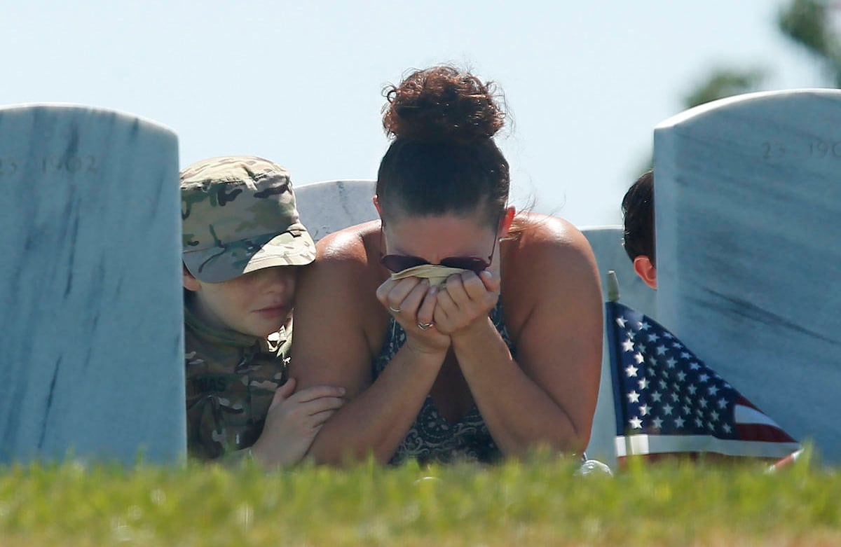 Heidi Hannah sostiene su cabeza en sus manos, mientras se le unen sus hijos Tomás, de 10 años, a la izquierda, y Lucas, de 8 a la derecha, en una visita del Día de los Caídos a la tumba de su hijo mayor, el especialista del Ejército Taylor Hannah, en el Sacramento Cementerio Nacional del Valle en Dixon, California, el lunes 25 de mayo de 2020. Los eventos del Día de los Caídos en el cementerio fueron cancelados este año debido a la pandemia de coronavirus. Taylor Hannah, de 22 años, murió el 1 de marzo de 2020 de una rara enfermedad de la sangre. (Foto AP / Rich Pedroncelli)