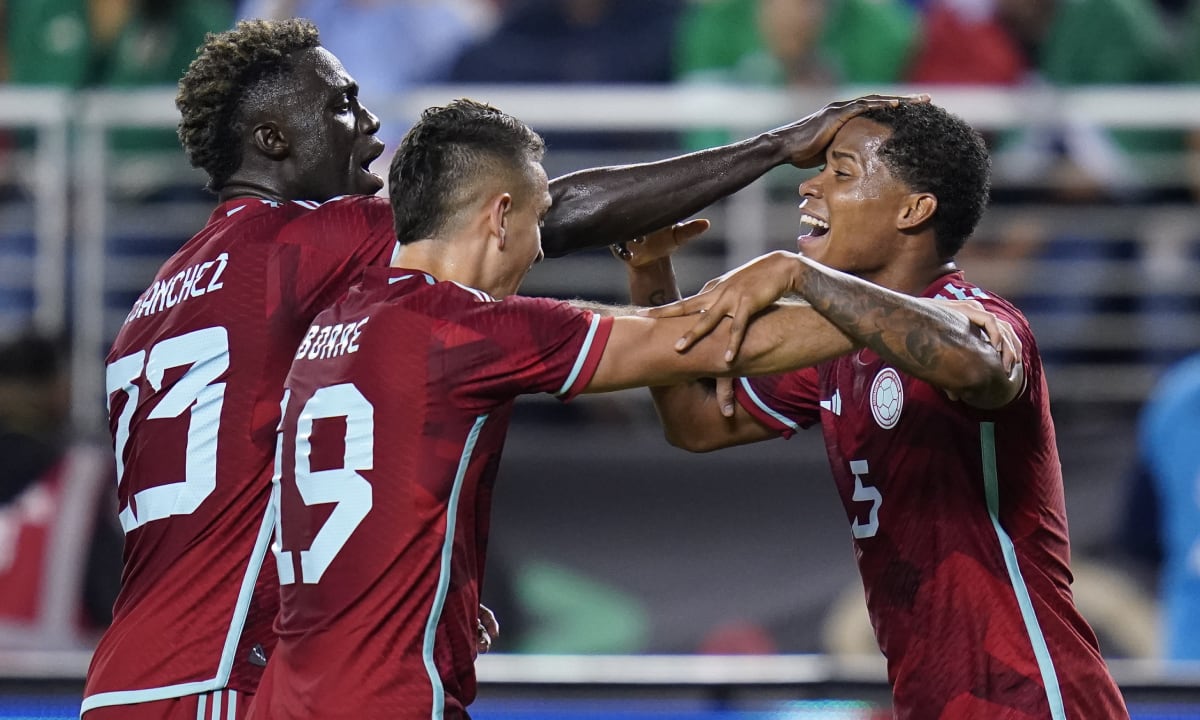 Colombia defender Davinson Sanchez (23) and forward Rafael Borre (19) celebrate with midfielder Wilmar Barrios (5), who scored a goal against Mexico during the second half of an international friendly soccer match in Santa Clara, Calif., Tuesday, Sept. 27, 2022. (AP/Godofredo A. Vásquez)