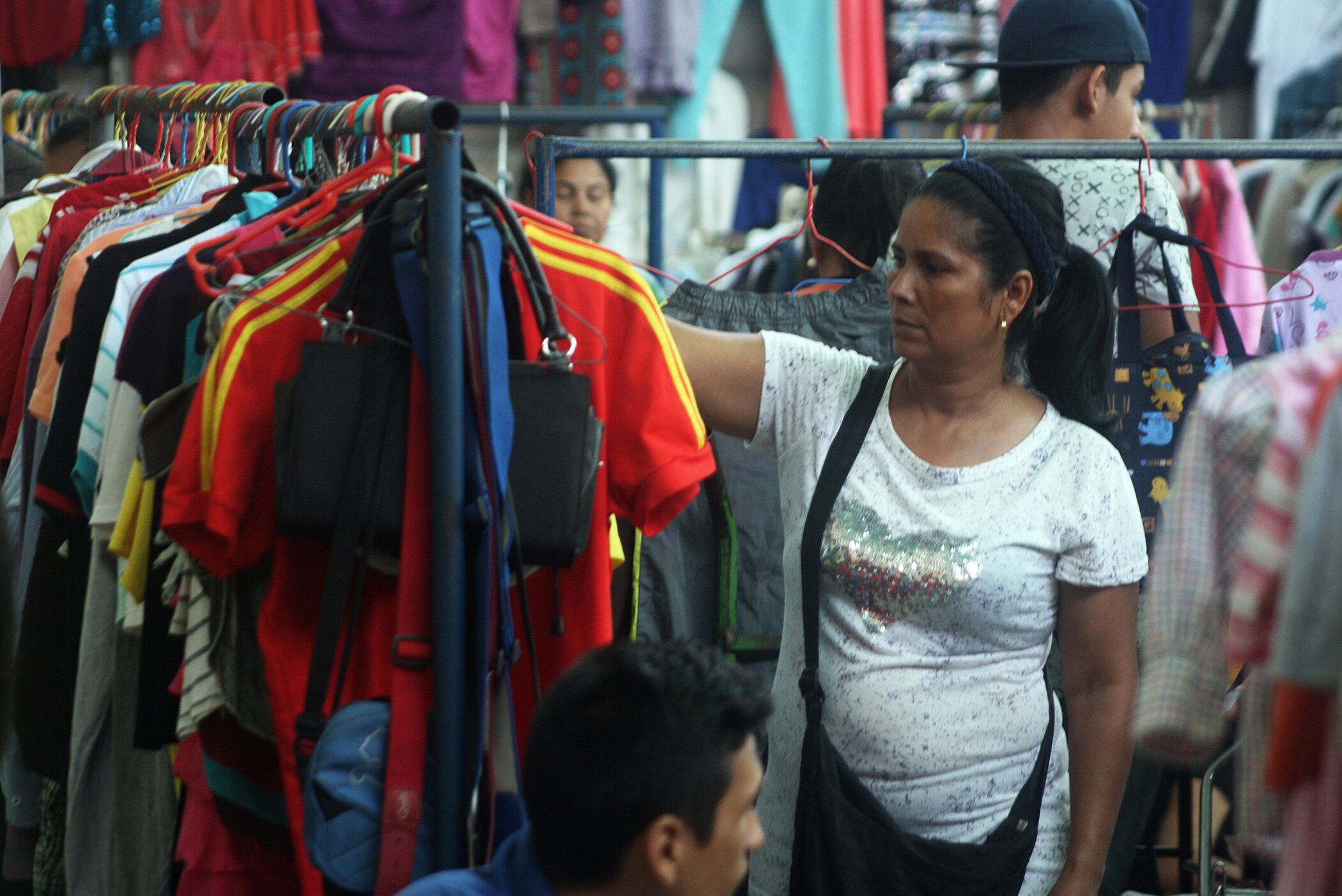 The serious economic situation, hyperinflation, falling purchasing power and high prices, force Venezuelans to go to the "garage sales" in warehouses and streets in the city of Maracaibo, Venezuela, on 15 December 2018. The traditional buying new clothes and shoes for the first time on Christmas and New Year's Eve, it is an unattainable dream for the inhabitants of this country whose inflation is boosted per hour, 3% every day. And the only immediate option to save money from the budget family is buying used clothes. The majority of the people who sell the clothes are by necessity to eat and another important group that leaves the country, and requires to leave those clothes and have the money to migrate. (Photo by Humberto Matheus/NurPhoto via Getty Images)