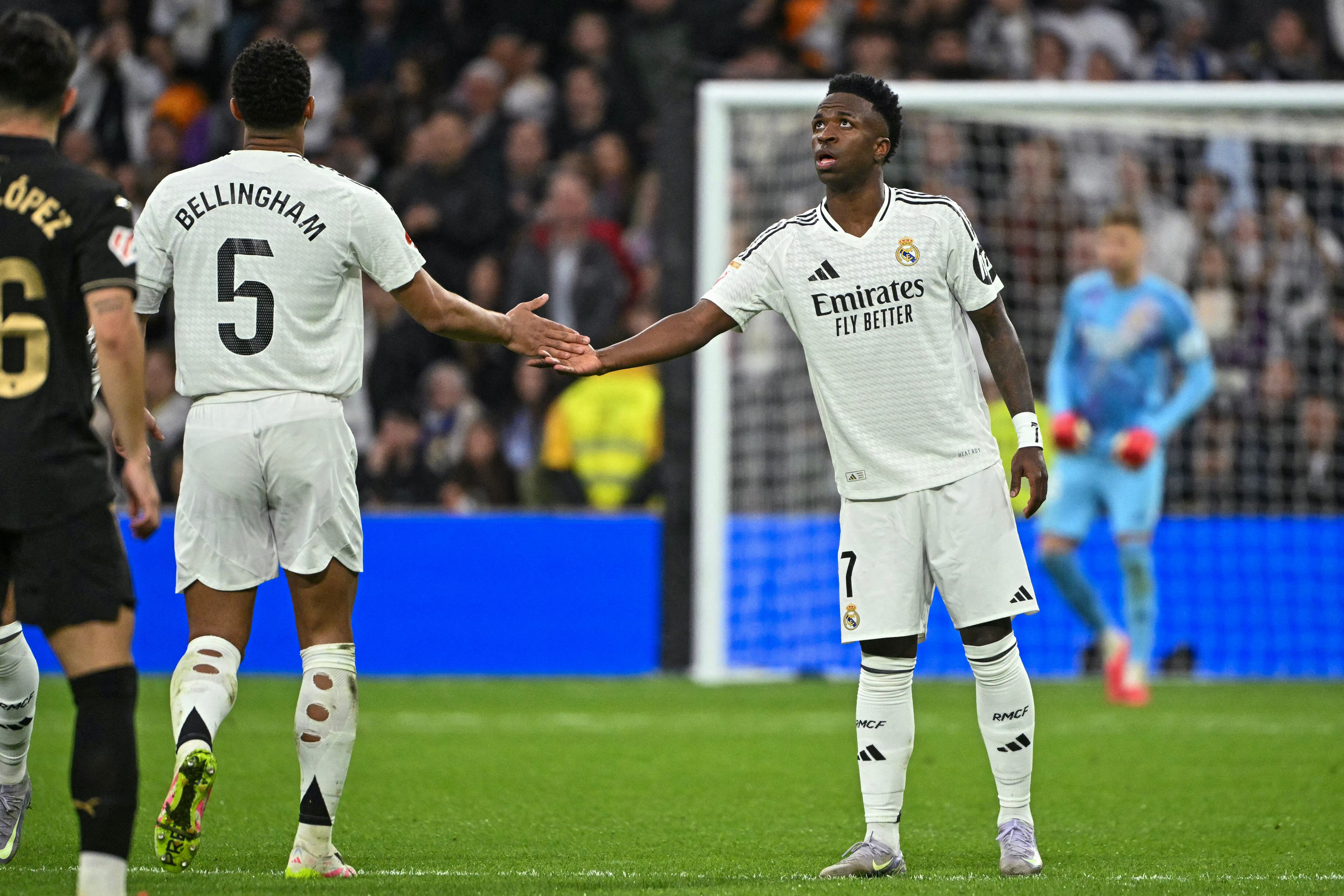 Real Madrid's Brazilian forward #07 Vinicius Junior (R) celebrates scoring their first goal during the Spanish league football match between Real Madrid CF and Valencia CF at the Santiago Bernabeu stadium in Madrid on April 5, 2025. (Photo by JAVIER SORIANO / AFP)