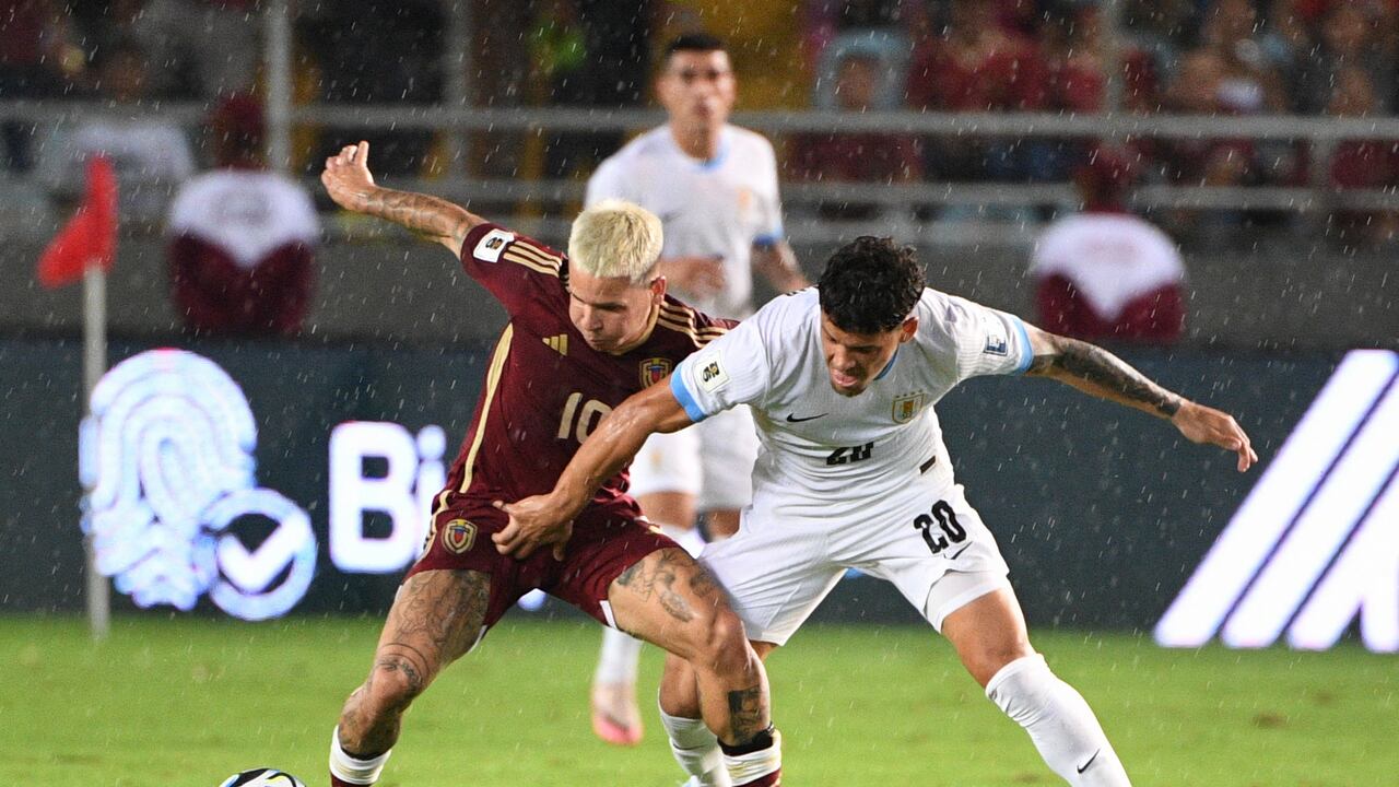 Venezuela's midfielder Yeferson Soteldo (L) and Uruguay's midfielder Maximiliano Araujo fight for the ball during the 2026 FIFA World Cup South American qualifiers football match between Venezuela and Uruguay at the Monumental stadium in Maturin, Venezuela, on September 10, 2024. (Photo by Federico Parra / AFP)