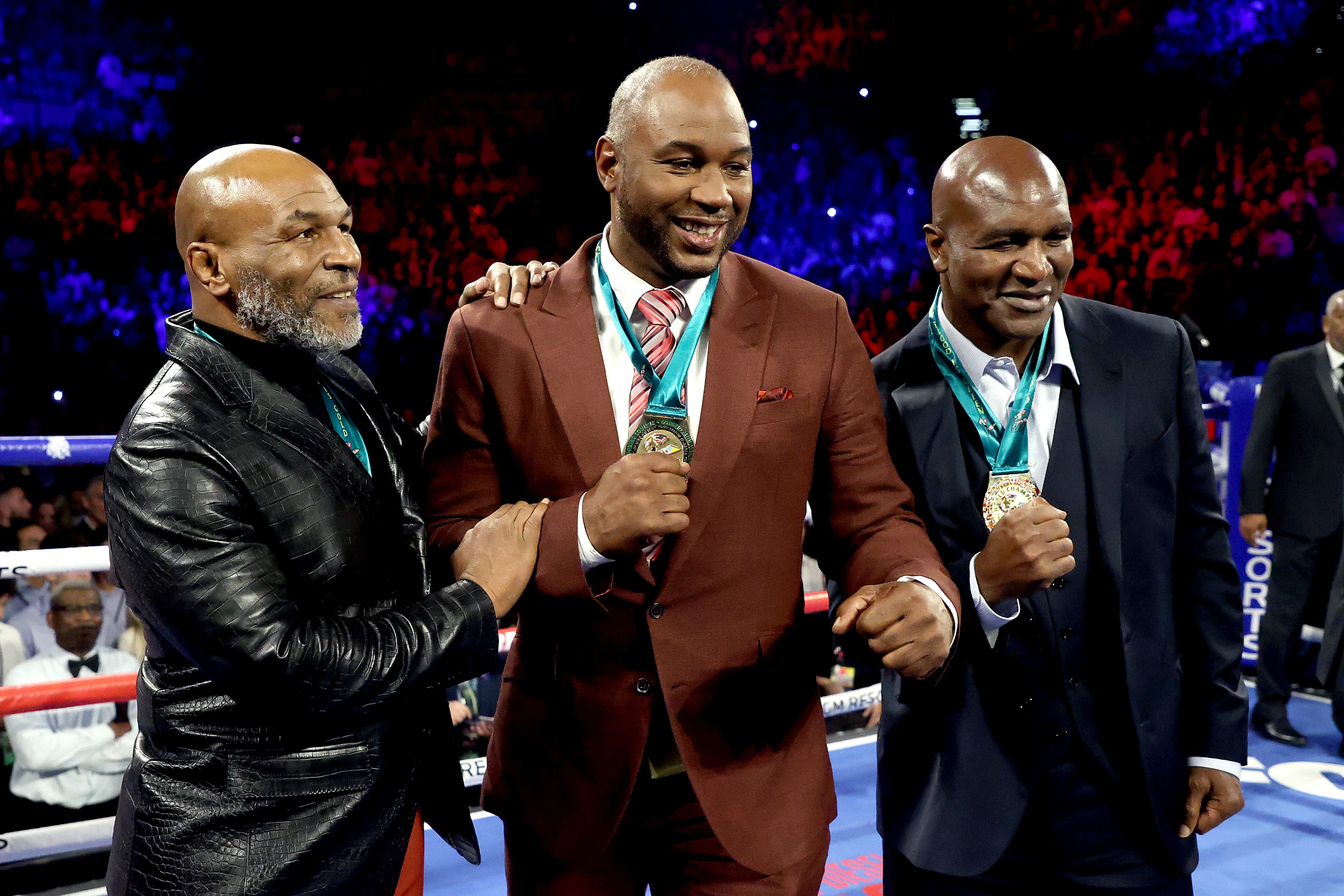 Los boxeadores Evander Holyfield y Mike tyson junto a Lenox Lewis