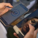 A Venezuelan migrant browses the CBP One mobile app searching for an appointment to enter the United States outside the temporary stay of the National Migration Institute (INM) in Ciudad Juarez, Chihuahua state, Mexico, on May 5, 2023. Under the intense desert sun, among sand and brush, hundreds of migrants crossed the Rio Grande from Mexico on the rumor that the United States would let them in. But their hopes were dashed as they fell prey, once again, to misinformation. Falsehoods and deceptions add to the ordeal of these people, first to reach the border through Mexico and then to obtain asylum in the United States. (Photo by HERIKA MARTINEZ / AFP)