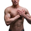 Muscular middle-aged man posing on white background, isolated studio shot, perfect male body