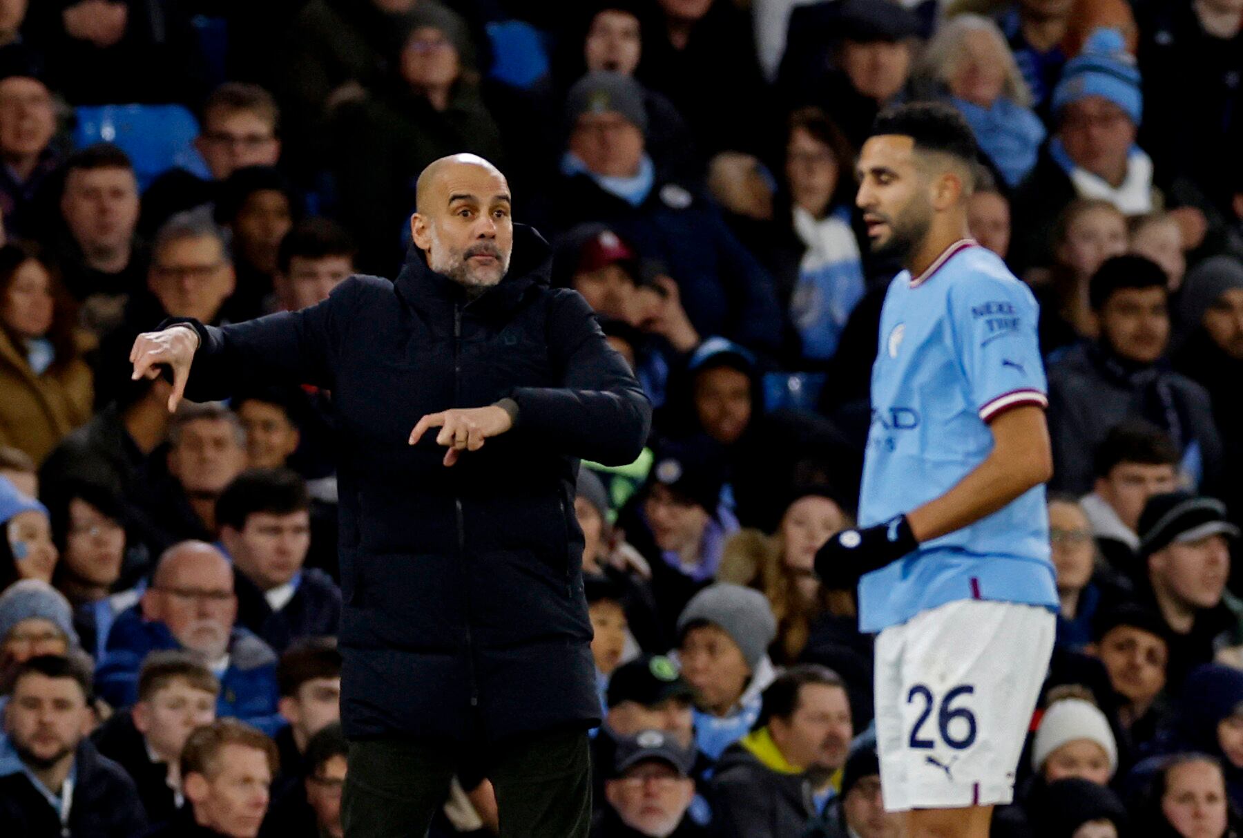 Soccer Football - FA Cup - Fourth Round - Manchester City v Arsenal - Etihad Stadium, Manchester, Britain - January 27, 2023 Manchester City's Riyad Mahrez receives instructions from manager Pep Guardiola Action Images via Reuters/Jason Cairnduff