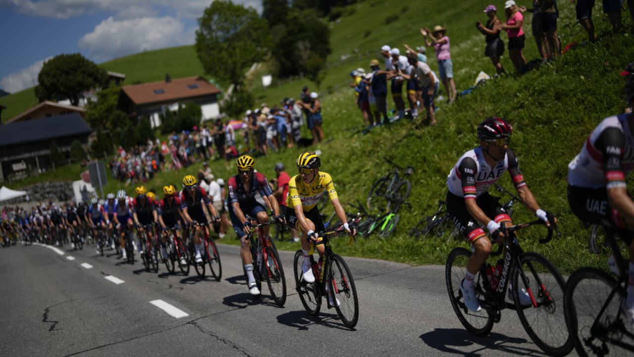 UAE Team Emirates riders, right, set the pace for their leader Slovenia's Tadej Pogacar, wearing the overall leader's yellow jersey, as they climb during the ninth stage of the Tour de France cycling race over 193 kilometers (119.9 miles) with start in Aigle, Switzerland and finish in Chatel les Portes du Soleil, France, Sunday, July 10, 2022. (AP/Thibault Camus)