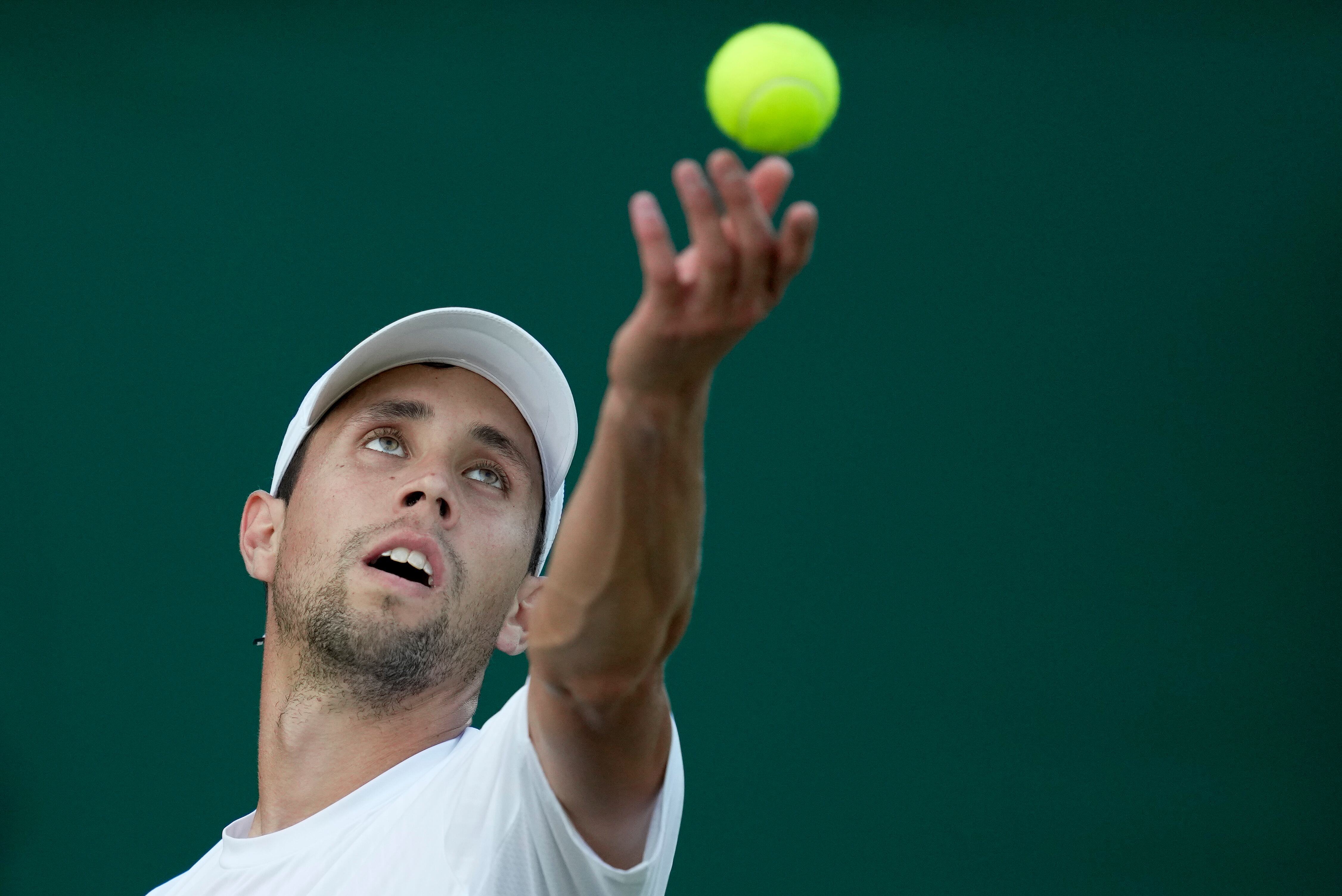 Colombia's Daniel Elahi Galan serves to Sweden's Mikael Ymer in a men's singles match on day five of the Wimbledon tennis championships in London, Friday, July 7, 2023. (AP Photo/Kin Cheung)