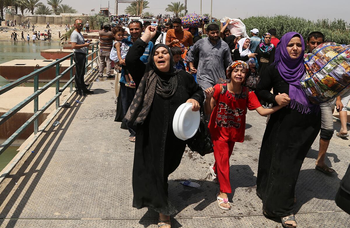 Los desplazados iraquíes de la ciudad de Ramadi cruzan el puente de Bzebiz para huir de los combates contra Estado Islámico. (AP/Karim Kadim)