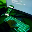 Phone, neon and hands typing on a keyboard while doing website design or coding on a computer at night. Technology, cellphone and male coder working late on webdesign project in office in the evening.