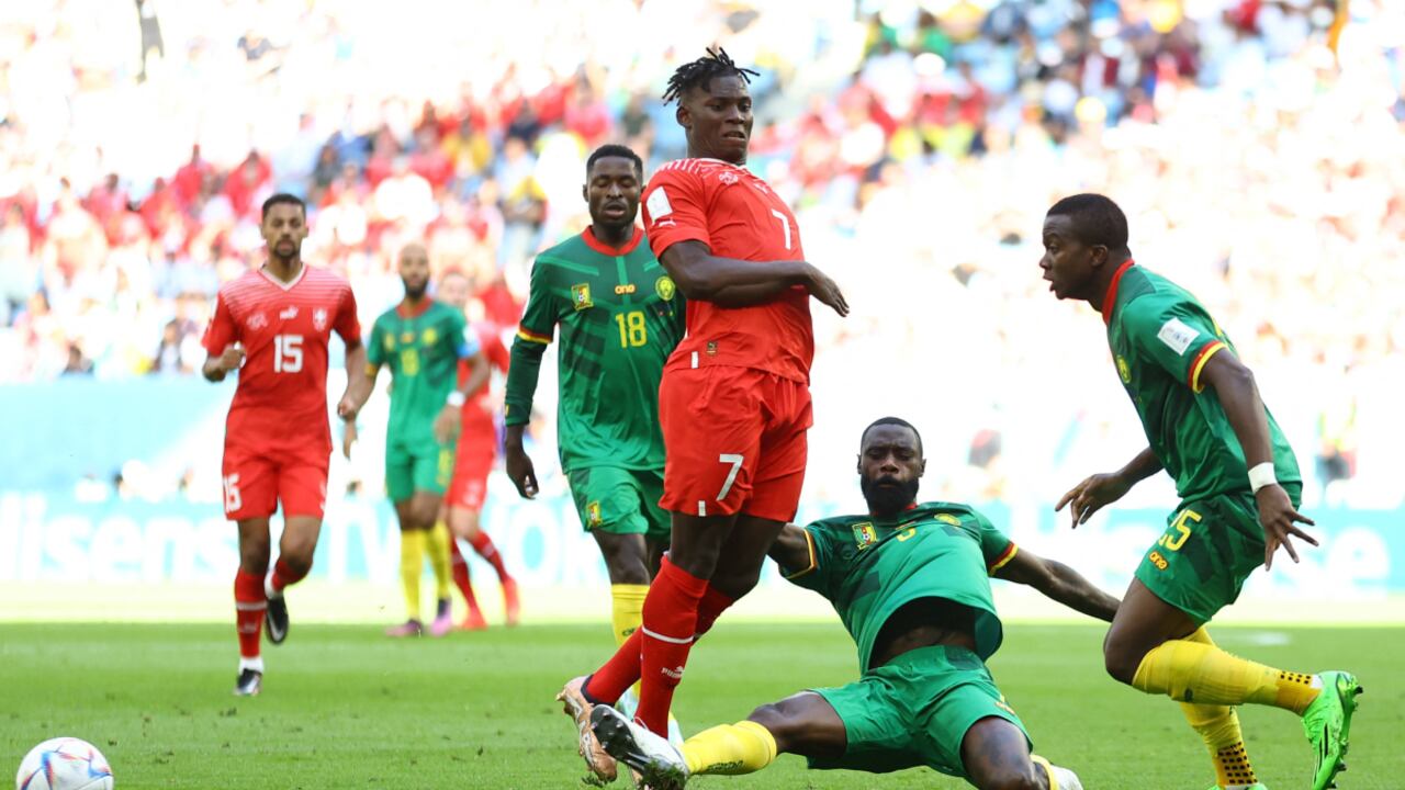 Soccer Football - FIFA World Cup Qatar 2022 - Group G - Switzerland v Cameroon - Al Janoub Stadium, Al Wakrah, Qatar - November 24, 2022 Switzerland's Breel Embolo in action with Cameroon's Nicolas Nkoulou and Nouhou Tolo REUTERS/Hannah Mckay