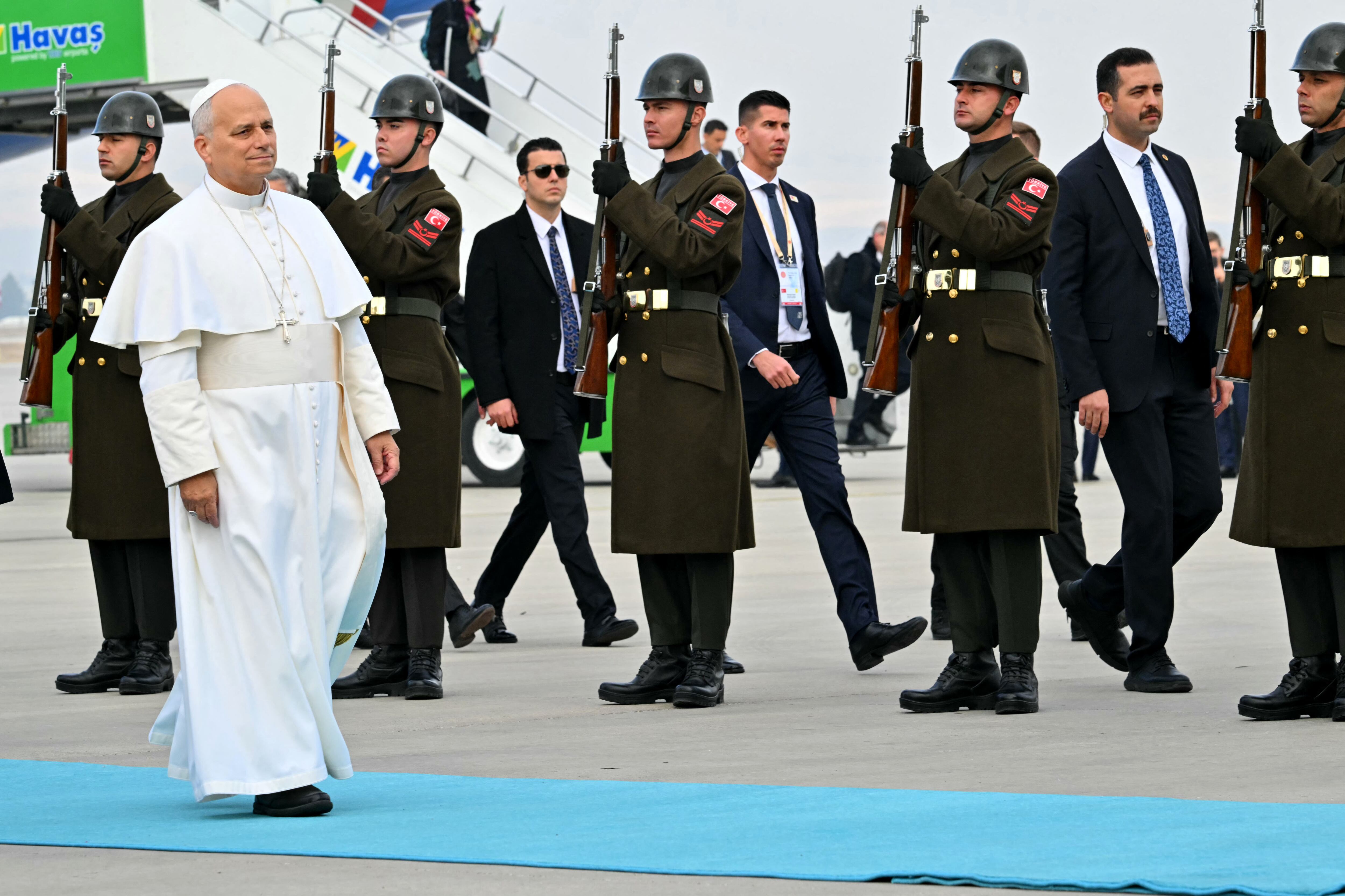 Pope Leo XIV disembarks from his plane after his arrival at Esenboga International Airport  in Ankara on November 27, 2025. Pope Leo XIV arrived in Turkey on the first overseas trip of his papacy, which will also take him to Lebanon. (Photo by Andreas SOLARO / AFP)