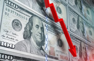 Loss in American dollar. Red arrow graph is showing a drastic fall over American dollar background. Selective focus. Horizontal composition with copy space.
