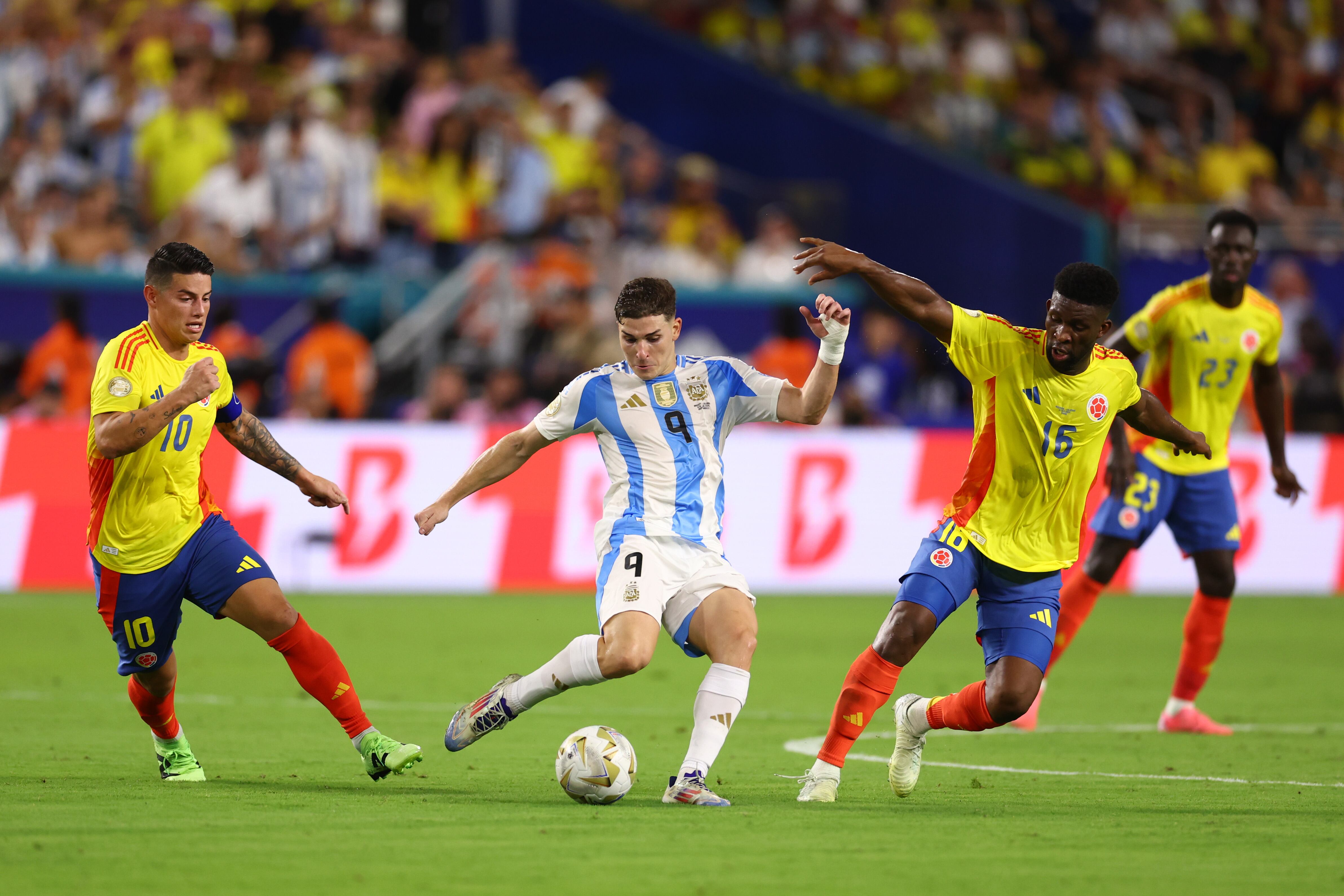 MIAMI GARDENS, FLORIDA - JULY 14: Julian Alvarez of Argentina kicks the ball against Mateus Uribe of Colombia during the CONMEBOL Copa America 2024 Final match between Argentina and Colombia at Hard Rock Stadium on July 14, 2024 in Miami Gardens, Florida. (Photo by Maddie Meyer/Getty Images)