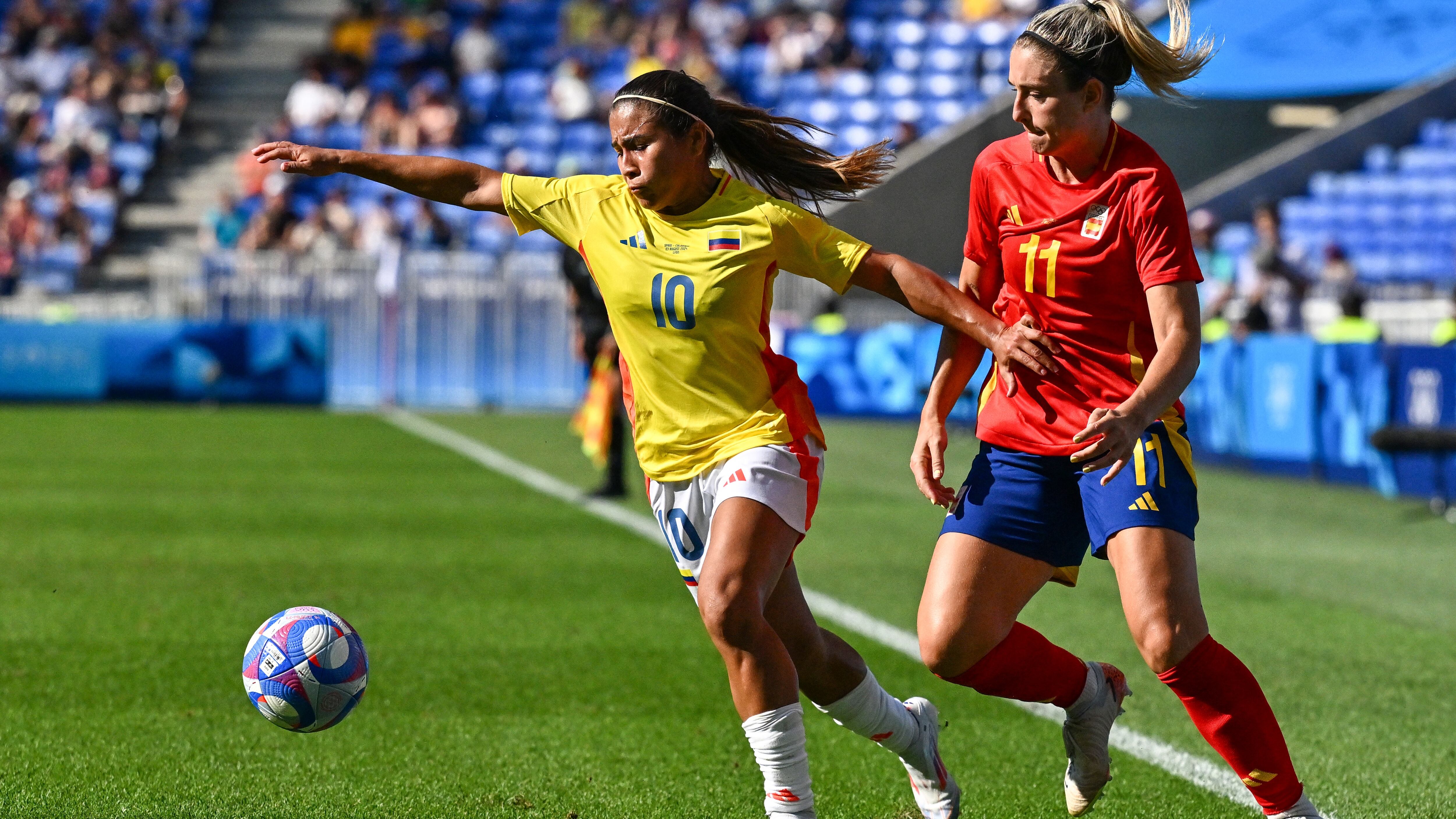 Colombia's midfielder #10 Leicy Santos and Spain's midfielder #11 Alexia Putellas compete for the ball during the women's quarter-final football match between Spain and Colombia during the Paris 2024 Olympic Games at the Lyon Stadium in Lyon on August 3, 2024. (Photo by Arnaud FINISTRE / AFP)