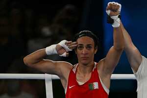 Algeria's Imane Khelif reacts after beating China's Yang Liu (Blue) in the women's 66kg final boxing match during the Paris 2024 Olympic Games at the Roland-Garros Stadium, in Paris on August 9, 2024. (Photo by Mauro PIMENTEL / AFP)