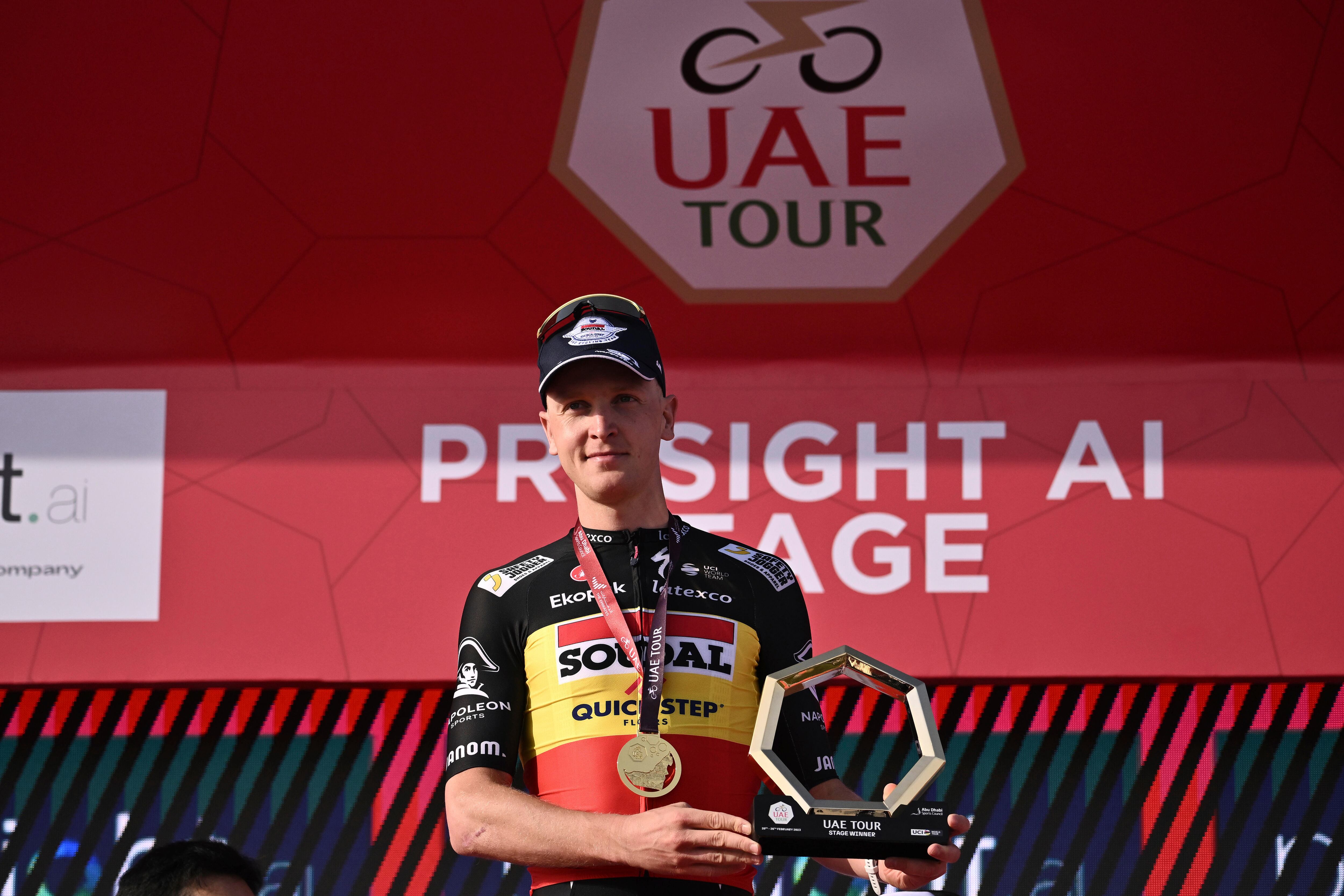 Belgium's Tim Merlier poses on podium after winning the opening stage of the UAE tour, from Al Dhafra Castle to Al Mirfa, Monday, Feb. 20, 2023. (Marco Alpozzi/LaPresse via AP)