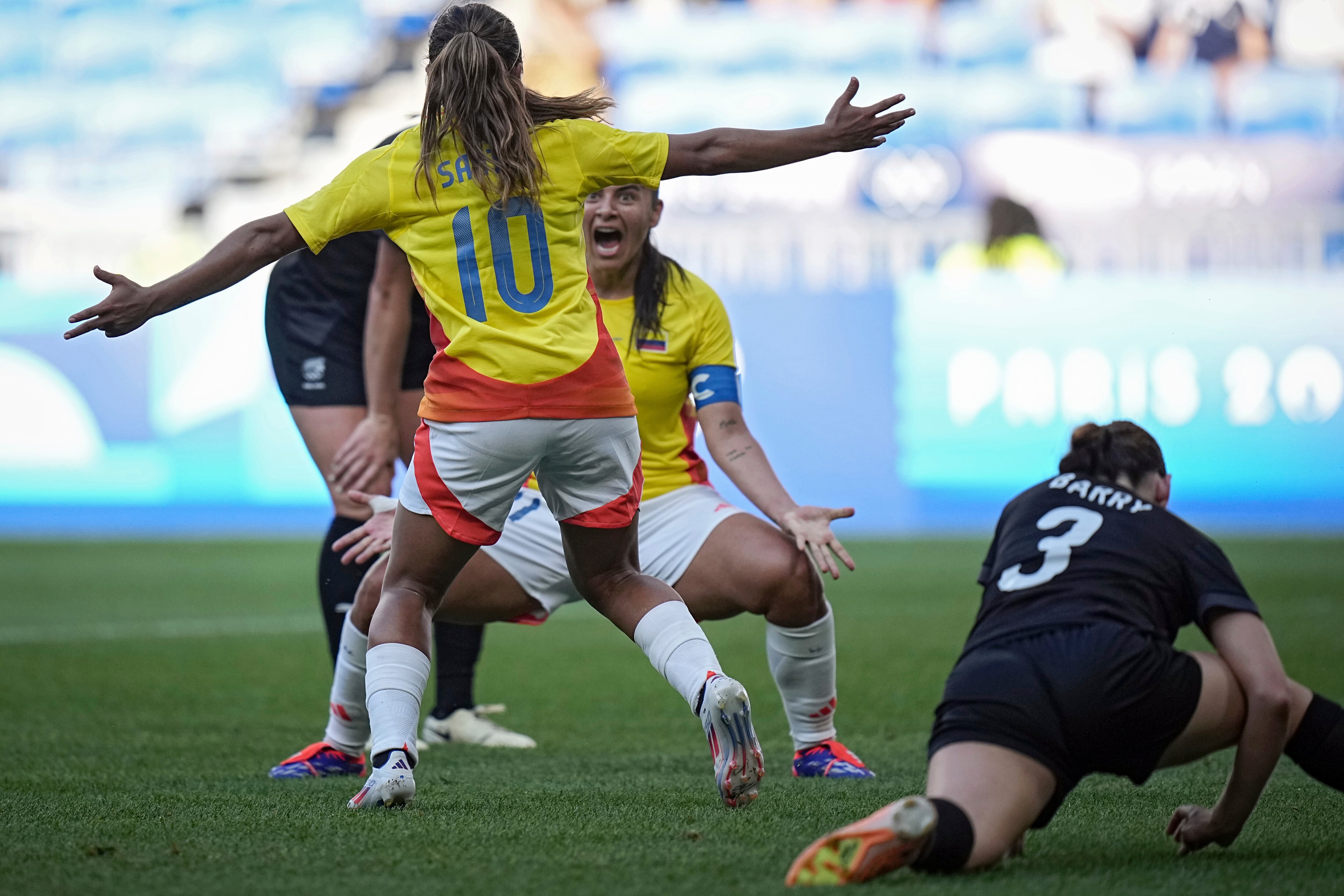 Colombia's Leicy Santos, back, celebrates with Colombia's Catalina Usme, front, after scoring during the women's Group A soccer match between New Zealand and Colombia at the Lyon stadium during the 2024 Summer Olympics, Sunday, July 28, 2024, in Decines, France. (AP Photo/Laurent Cipriani)