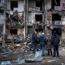 People look at the damage following a rocket attack the city of Kyiv, Ukraine, Friday, Feb. 25, 2022. (AP Photo/Emilio Morenatti)