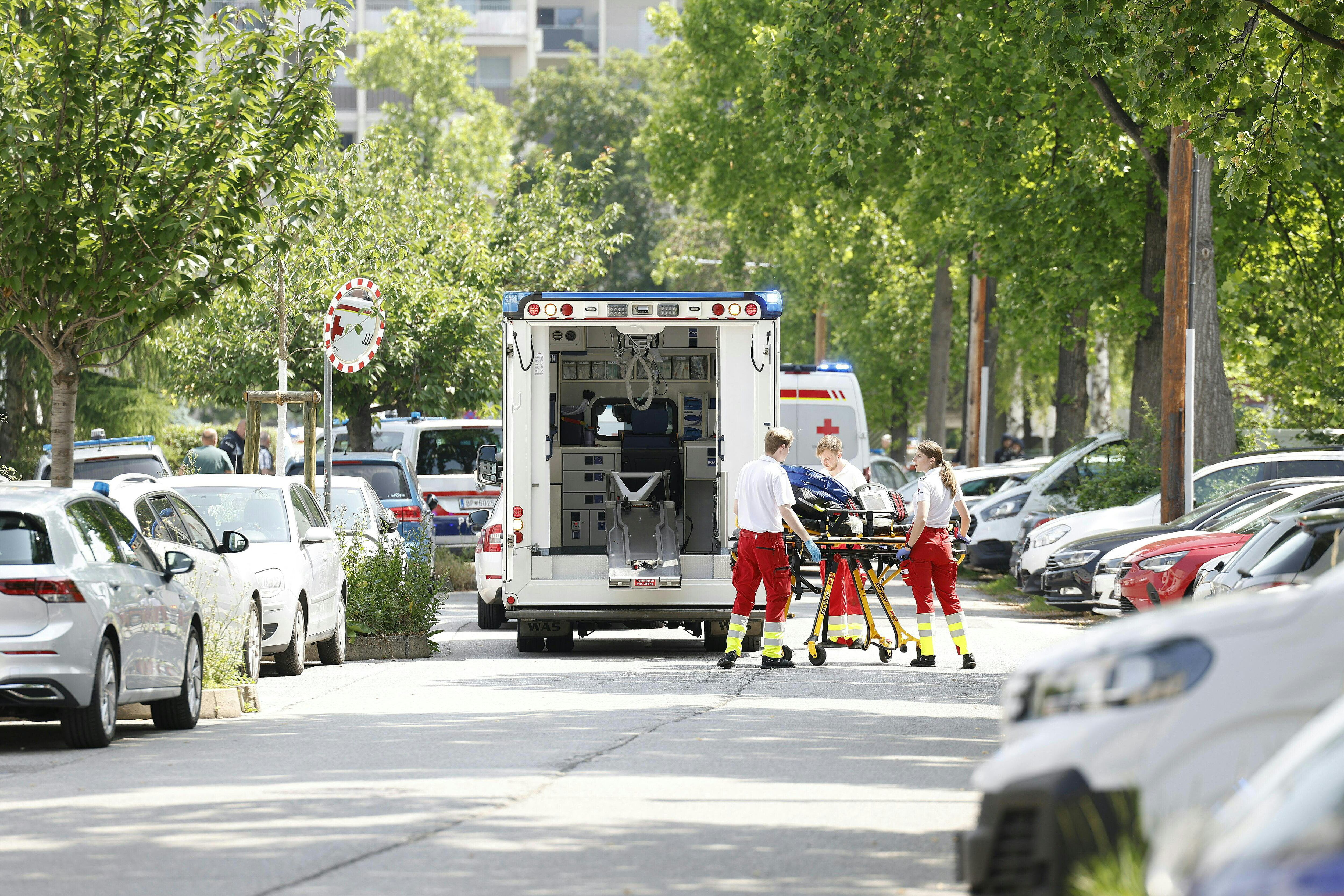 Rescue paramedics are seen next to an ambulance car close to a school where, according to reports, several people died in a shooting, on June 10, 2025 in Graz, southeastern Austria. Several people died in a school shooting, including the attacker, Austrian broadcaster ORF quoted the interior ministry as saying. (Photo by ERWIN SCHERIAU / APA / AFP) / Austria OUT / AUSTRIA OUT / AUSTRIA OUT