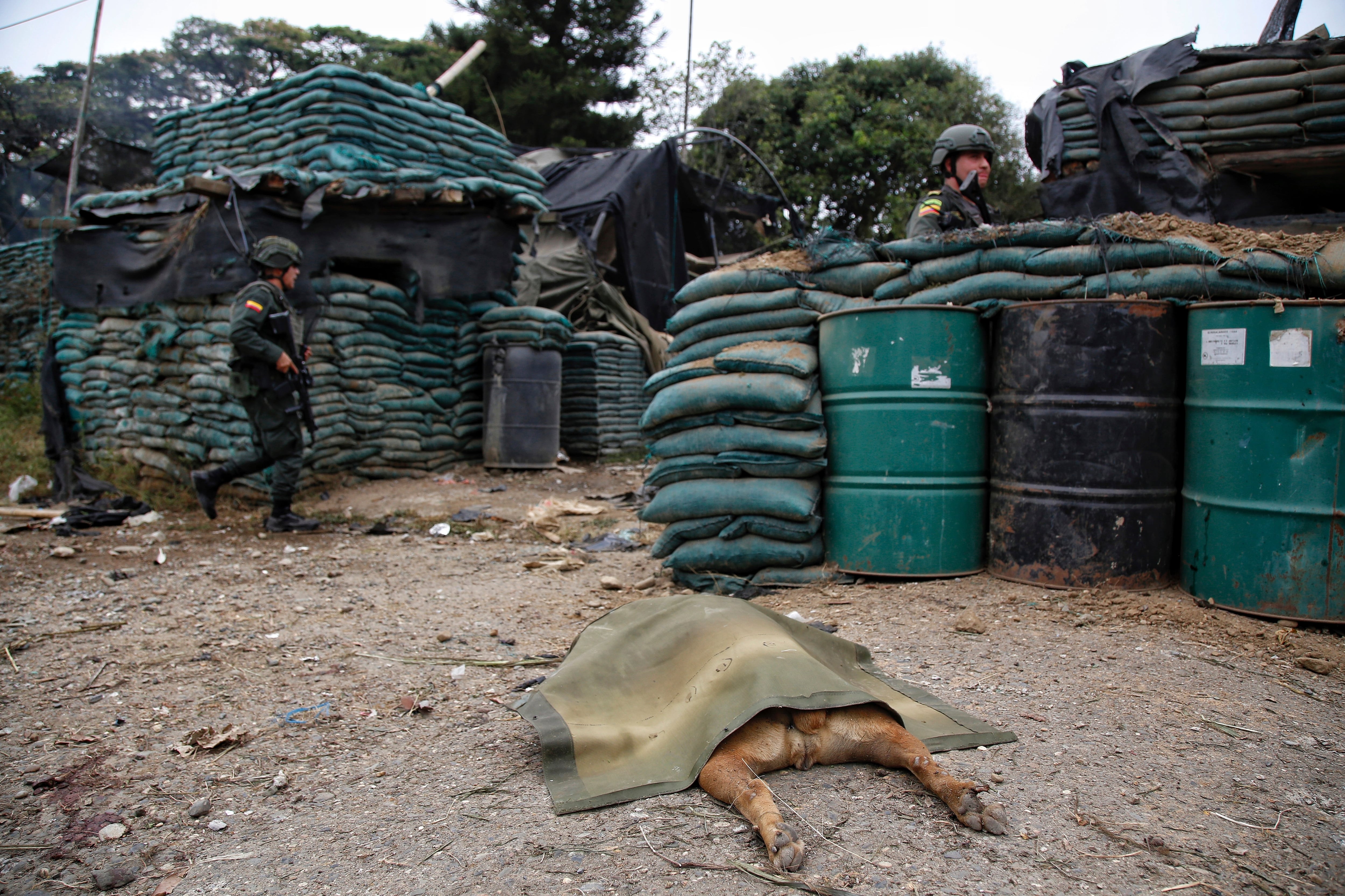 Police stand guard before a damaged police station after a car bomb exploded, in Timba, Cauca, Colombia, Sunday, Aug. 13, 2023. According to police, the car bomb killed one police officer. (AP Photo/Andres Quintero)