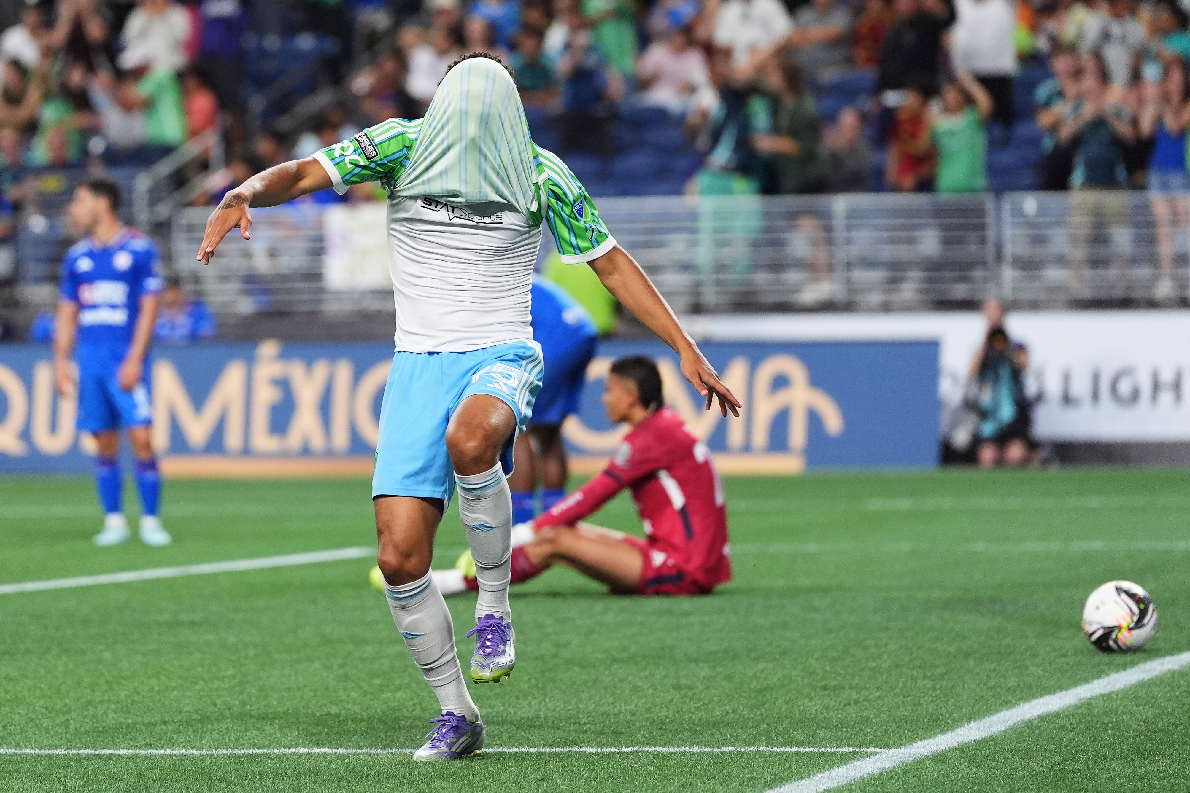 Seattle Sounders forward Osaze De Rosario puts his jersey over his head while celebrating his goal against Cruz Azul goalkeeper Kevin Mier, back right, during the second half of a Leagues Cup soccer match Thursday, July 31, 2025, in Seattle. (AP Photo/Lindsey Wasson)